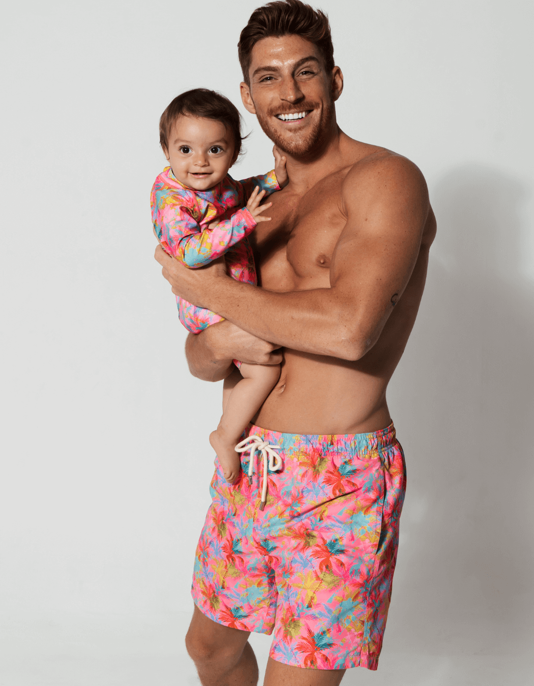 Father & Baby Pink Palm, front view. Father and son matching swim shorts.