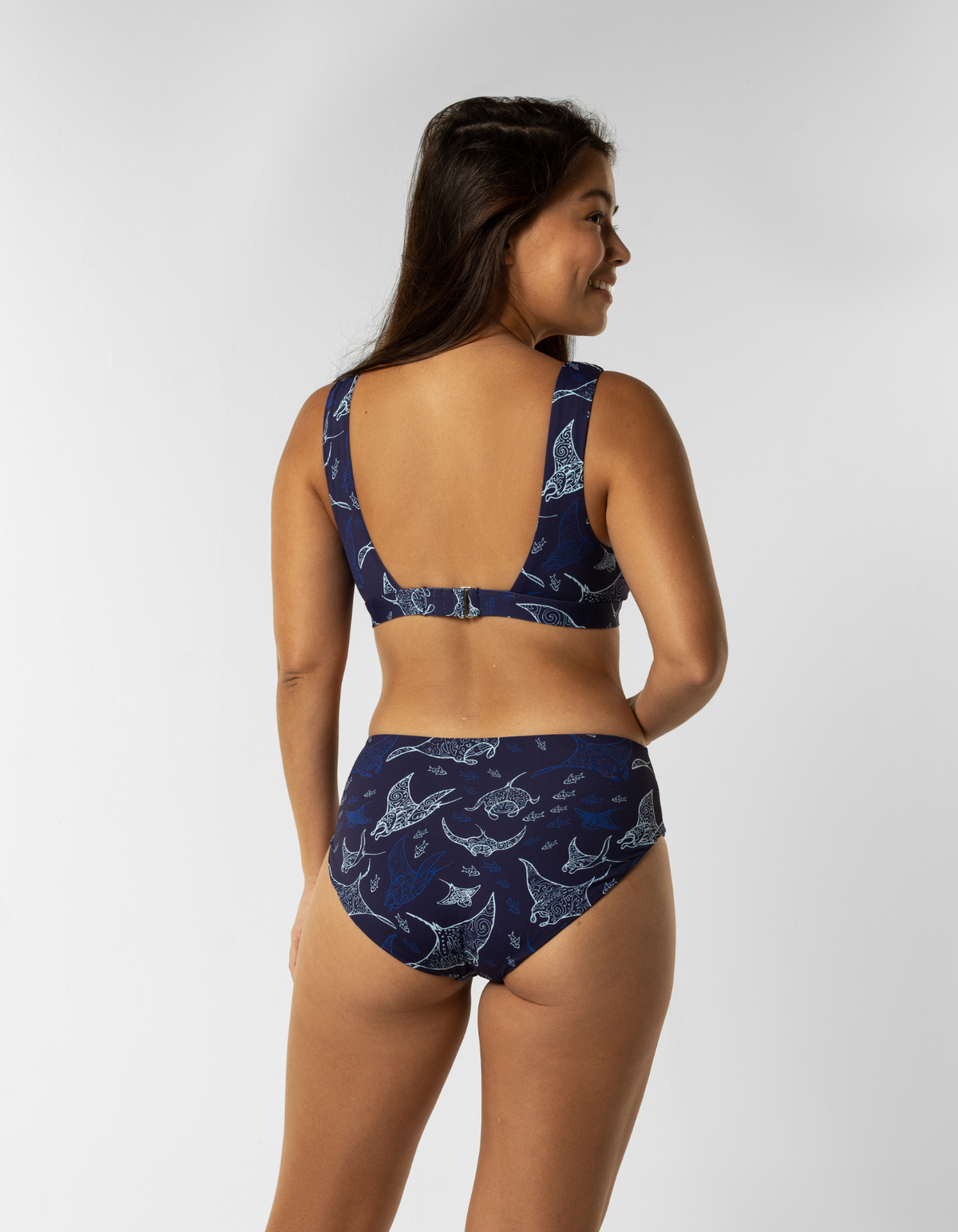 Dune – Ocean Manta Womens Plunge Bikini Top, lifestyle shot. Sustainable womens swimwear.