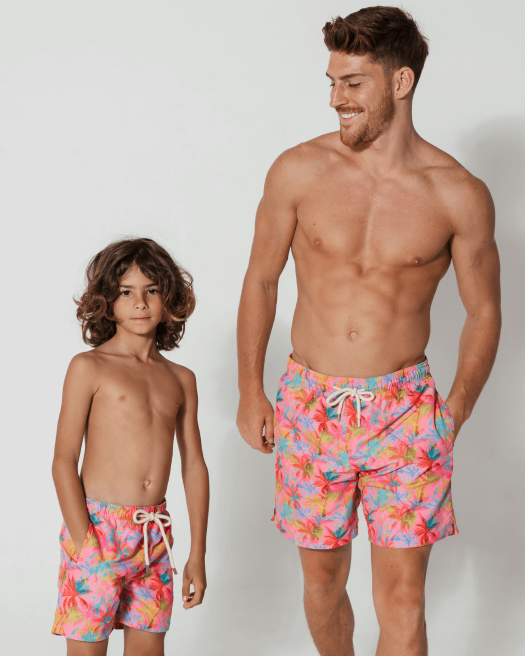 Father & Son Swim Shorts Pink Palm, front view. Father and son matching swim shorts.
