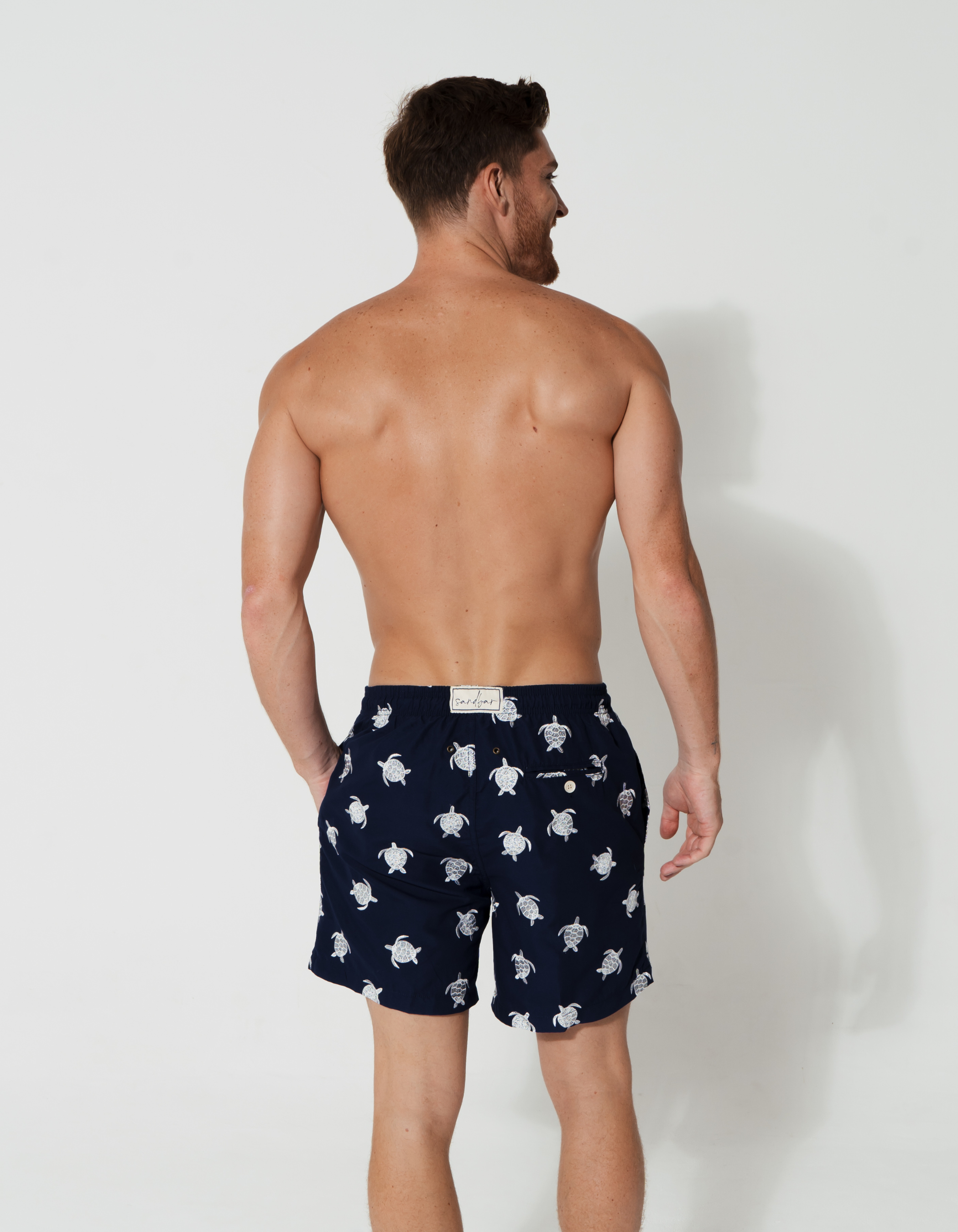 Embroidered Turtle Mens Swim Shorts, lifestyle shot. Embroidered mens swim shorts.