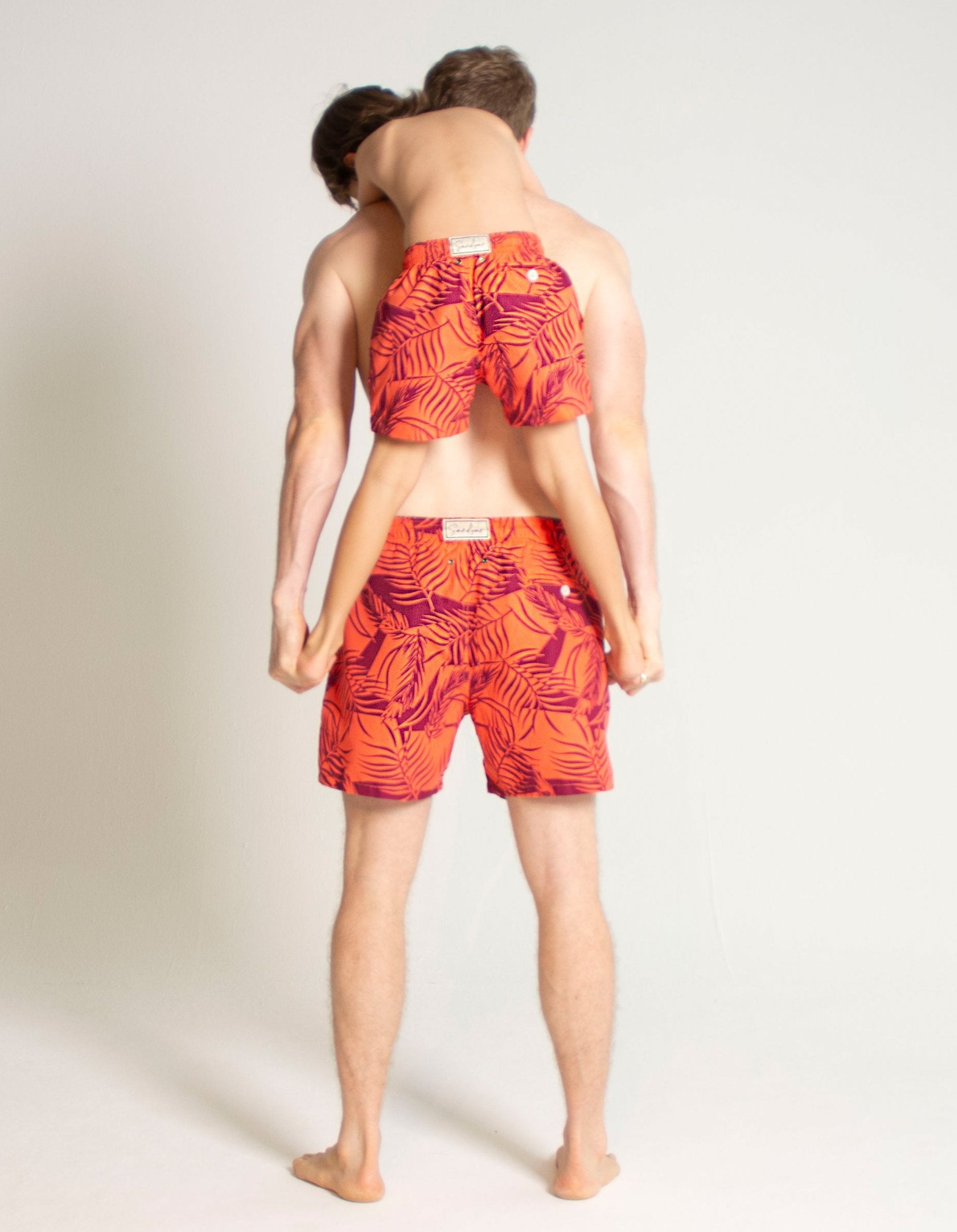 Sunset Palm Boys Swim Shorts, back view. Sustainable boys swimwear.