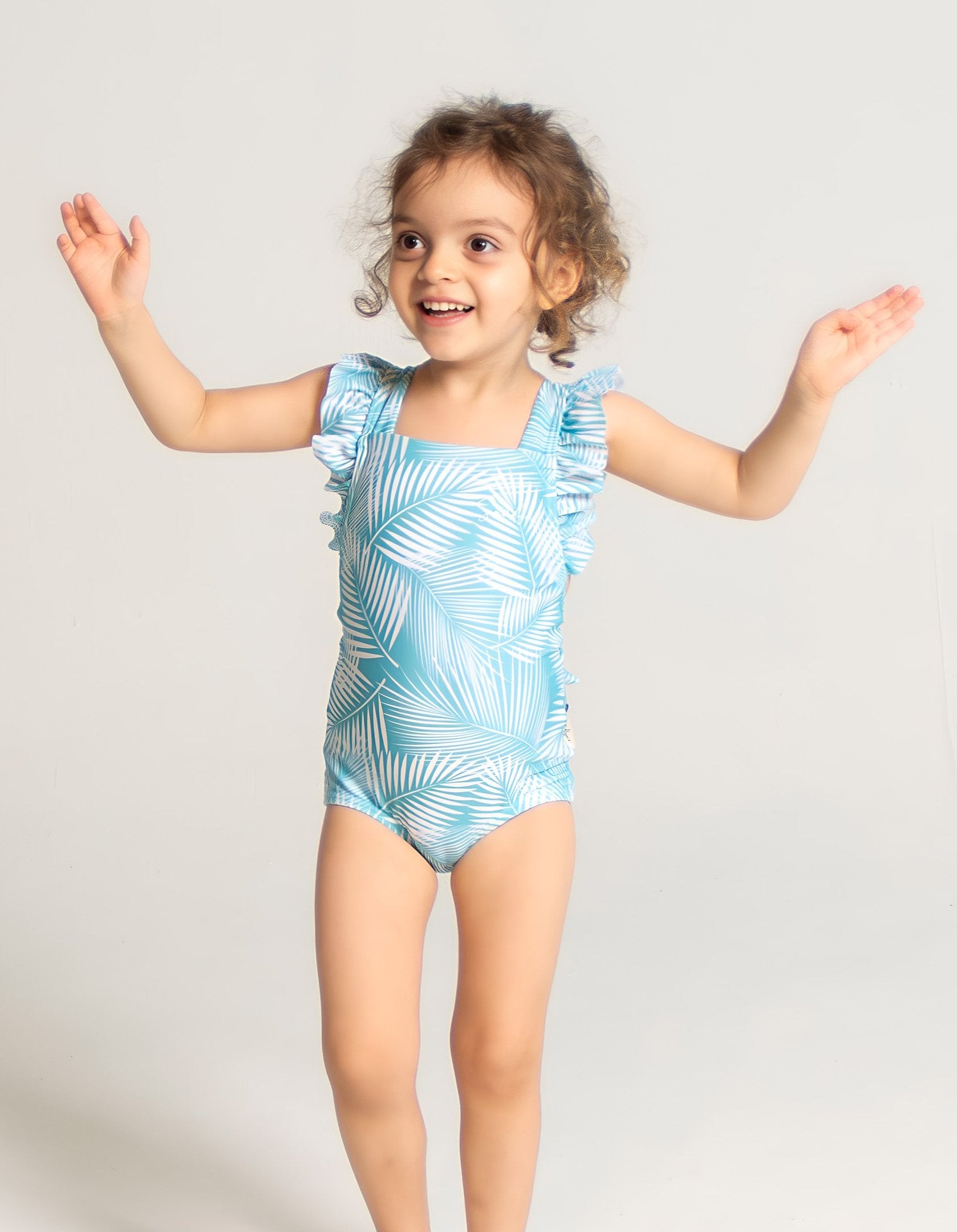Green Fern Girls Ruffle Swimsuit, front view. Sustainable girls swimwear.