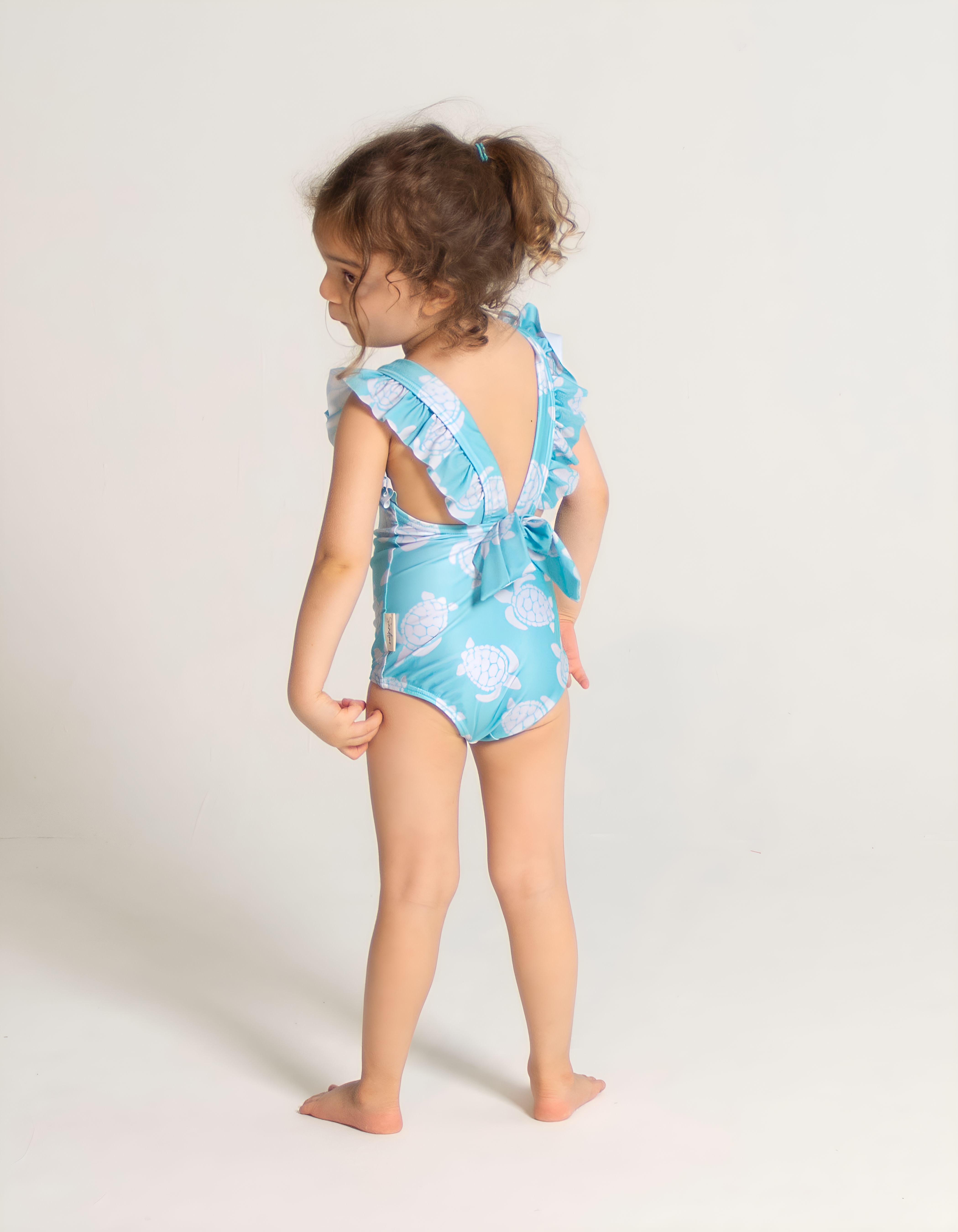 Maldives Blue Turtle Girls Ruffle Swimsuit, back view. Sustainable girls swimwear.