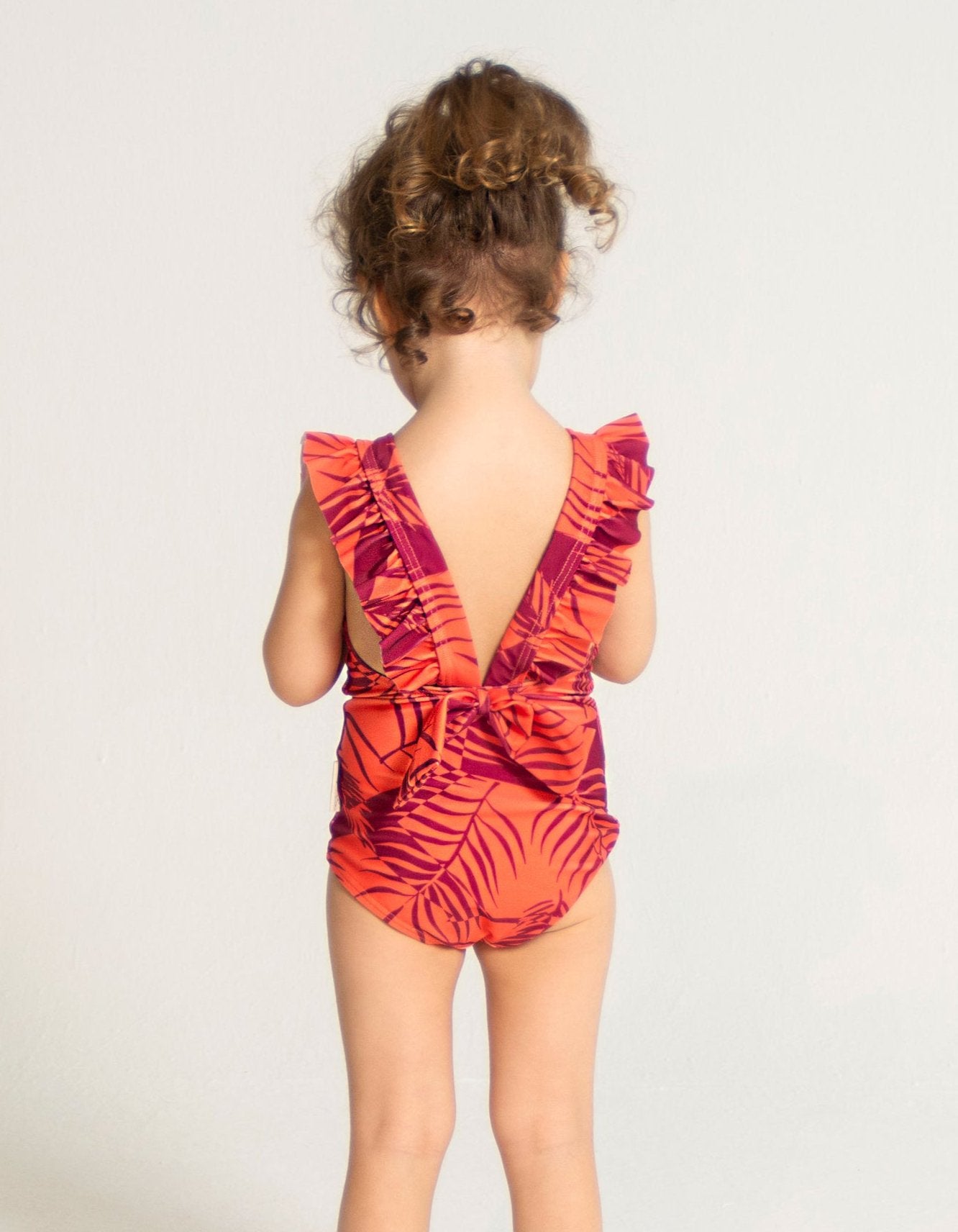 Sunset Palm Girls Ruffle Swimsuit, back view. Sustainable girls swimwear.
