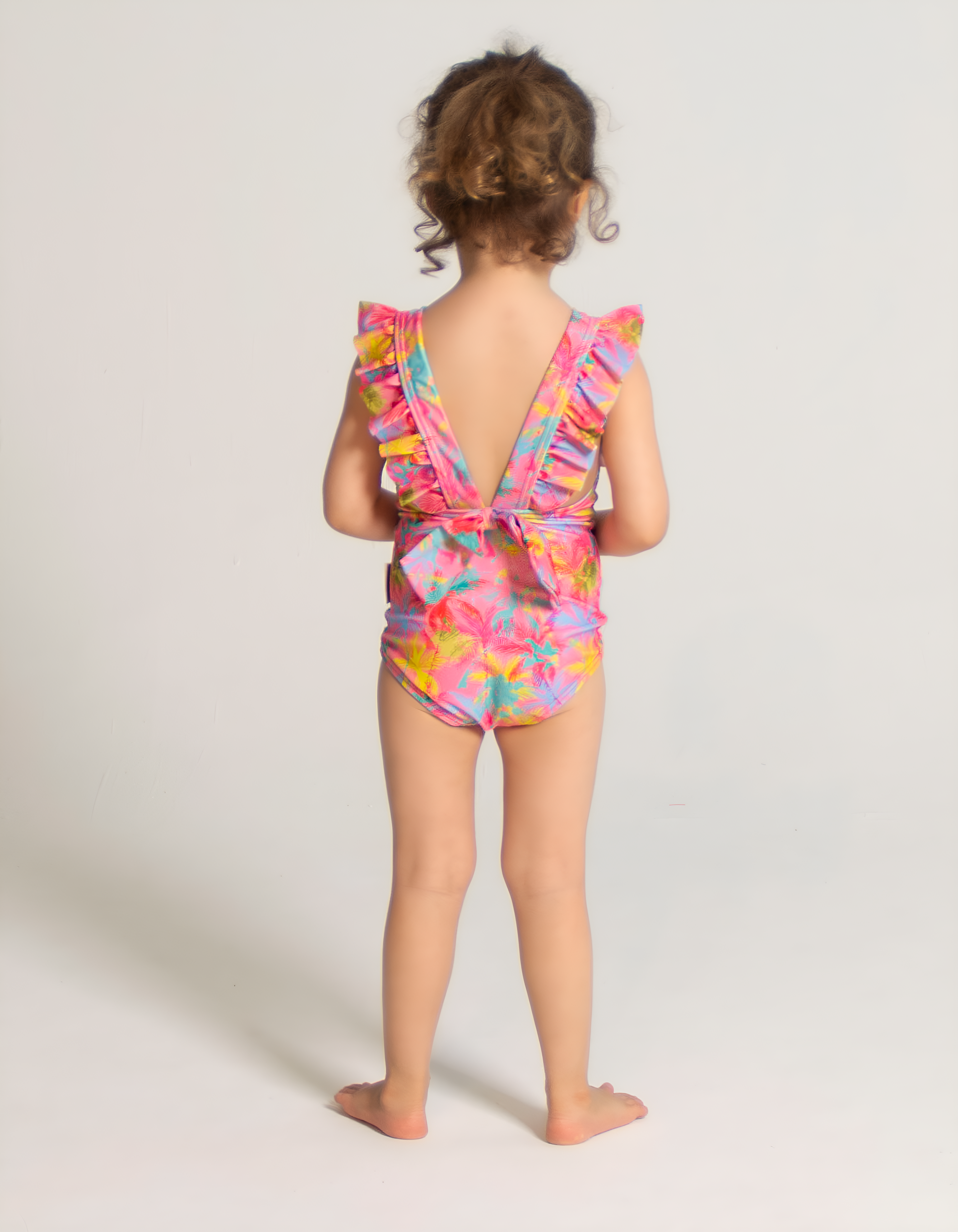 Pink Palm Girls Ruffle Swimsuit, back view. Sustainable girls swimwear.