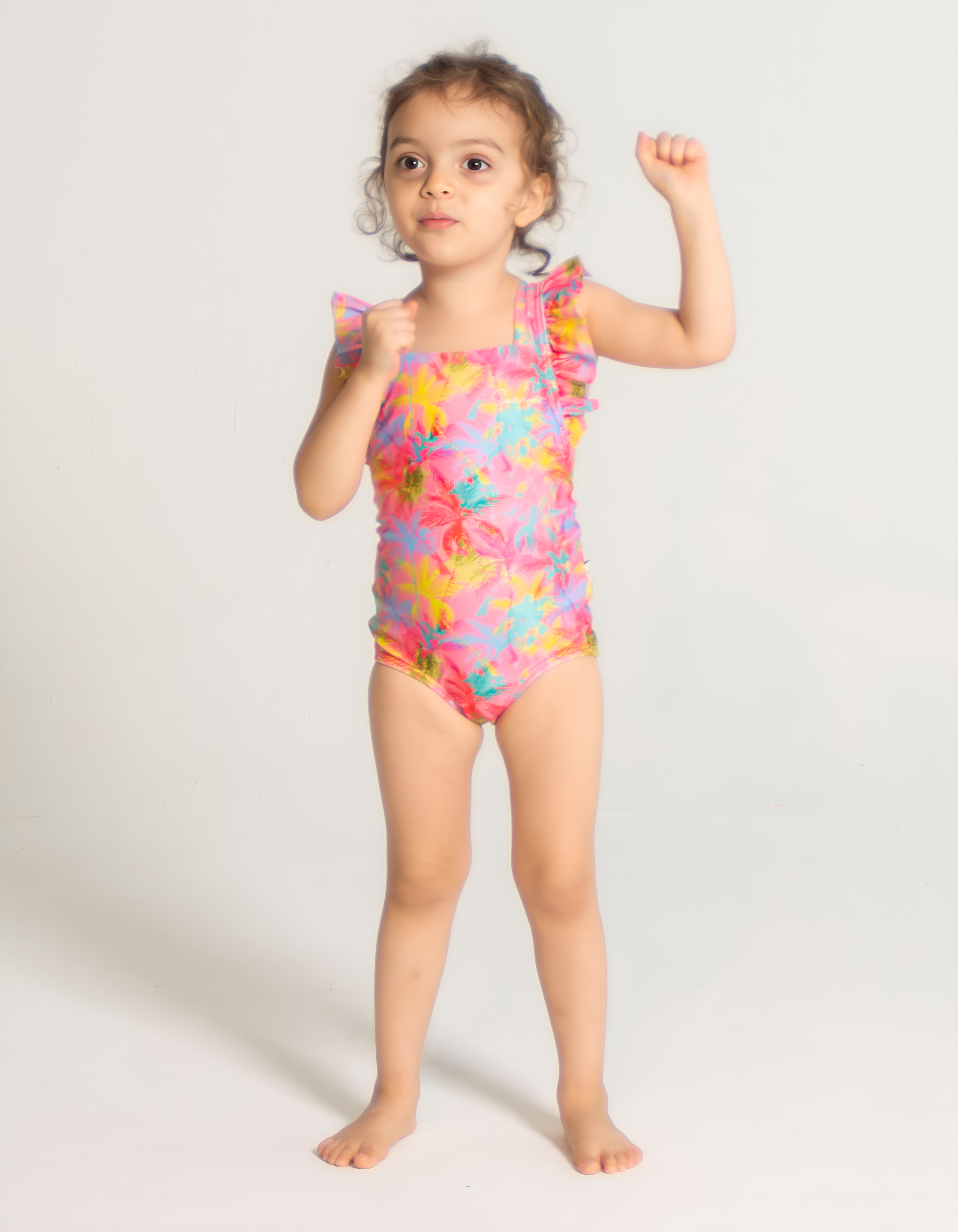 Pink Palm Girls Ruffle Swimsuit, front view. Sustainable girls swimwear.