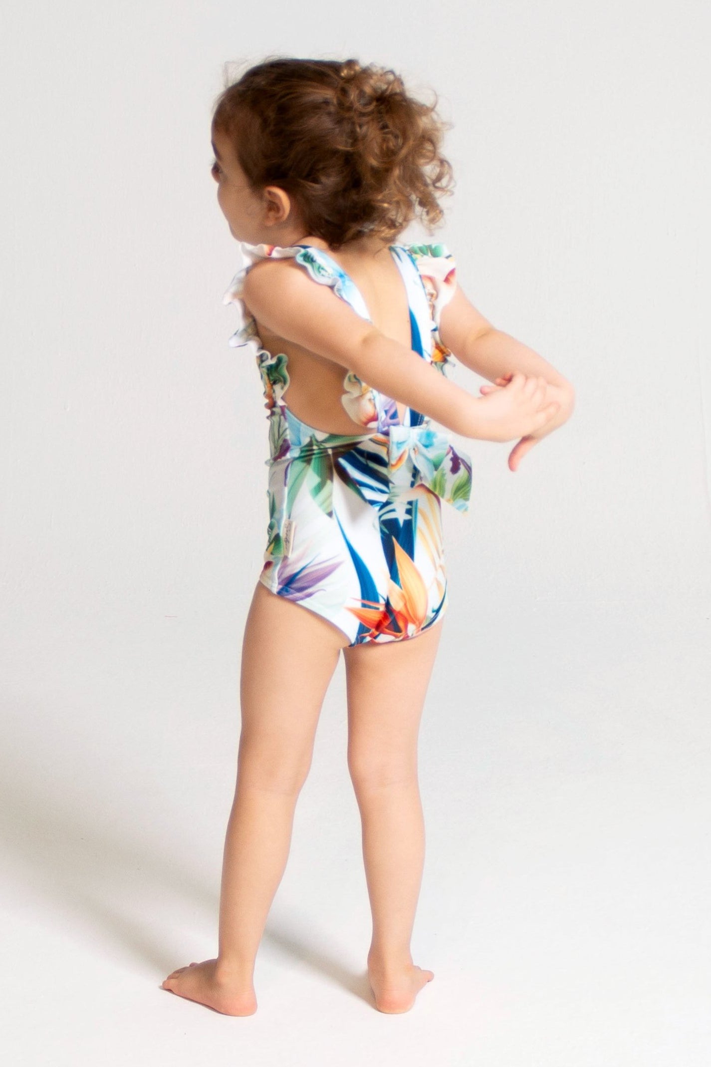 Bird of Paradise Girls Ruffle Swimsuit, back view. Sustainable girls swimwear.