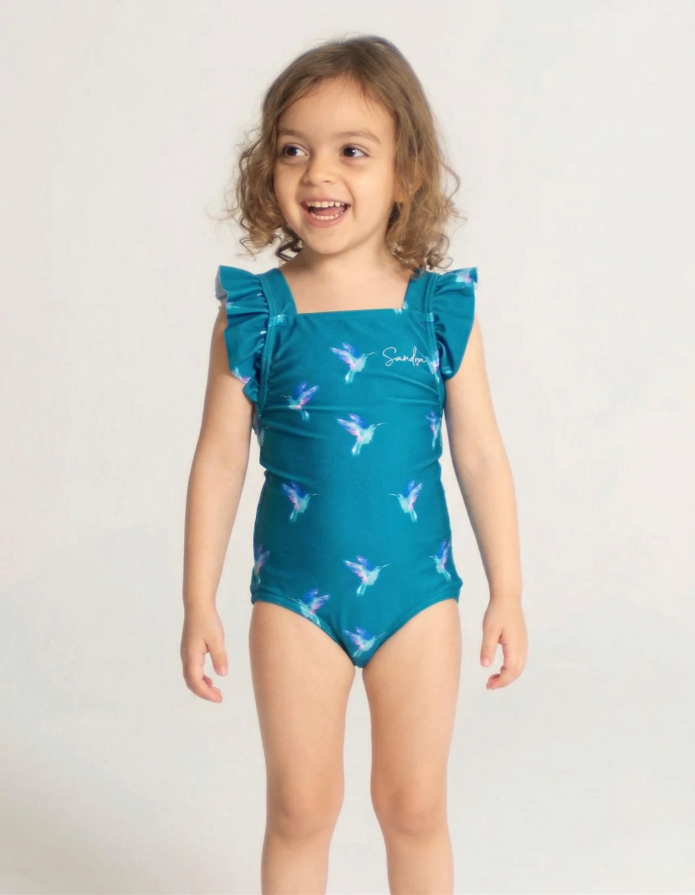 Hummingbird Girls Ruffle Swimsuit, front view. Sustainable girls swimwear.