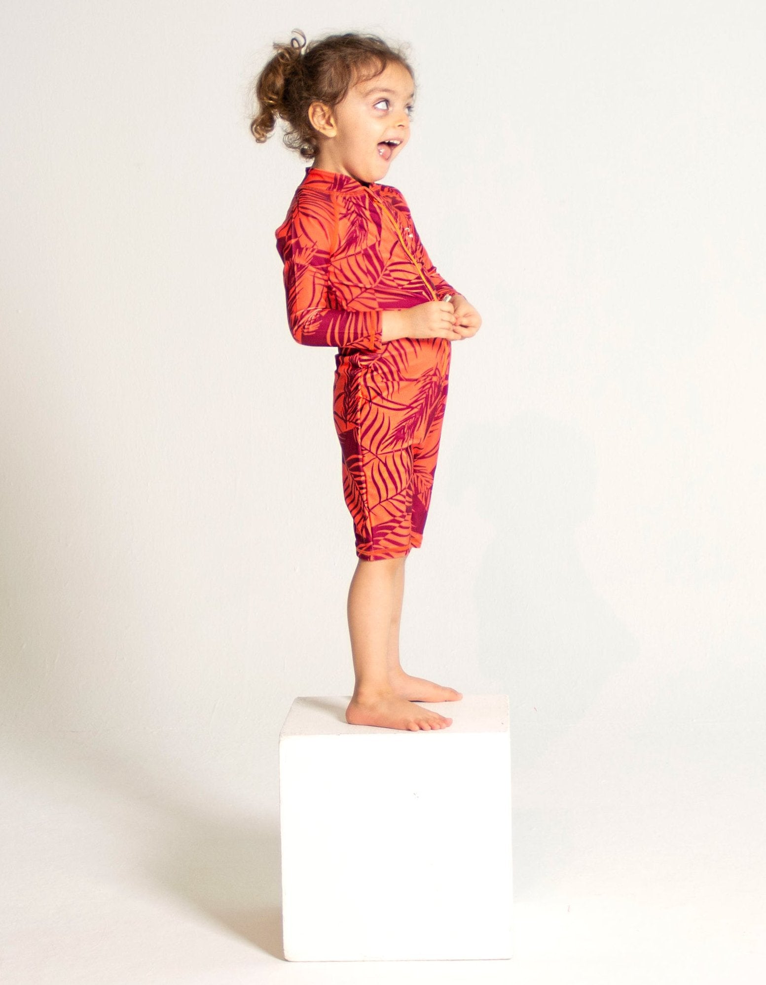 Sunset Palm Kids Body Suit, front view. Sustainable kids swimwear.