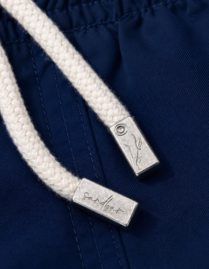 Deep Blue Boys Swim Shorts, mental string end caps. Sustainable boys swimwear.