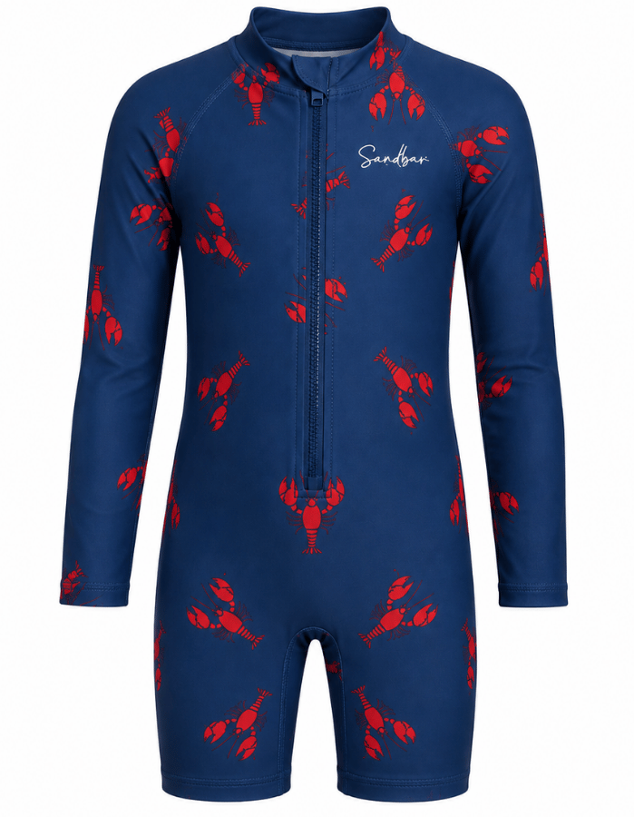 A long-sleeve, one-piece children's swim shirt in navy blue with a red lobster print pattern and a front zipper. The brand name 'Sandbar' is printed in white script on the left chest.