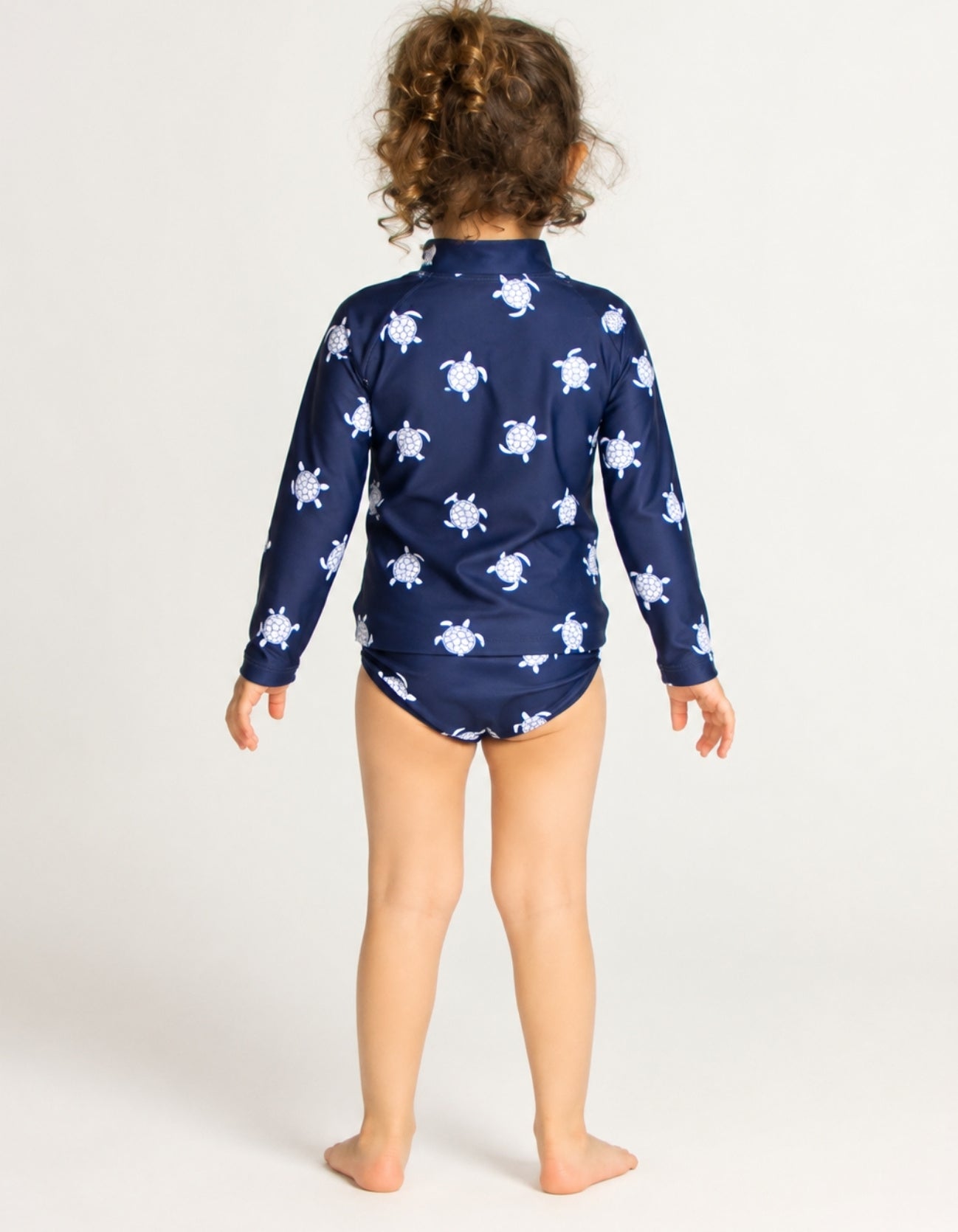 Girls navy turtle print rash guard set with matching bikini bottoms, long sleeve kids UPF swimwear back view