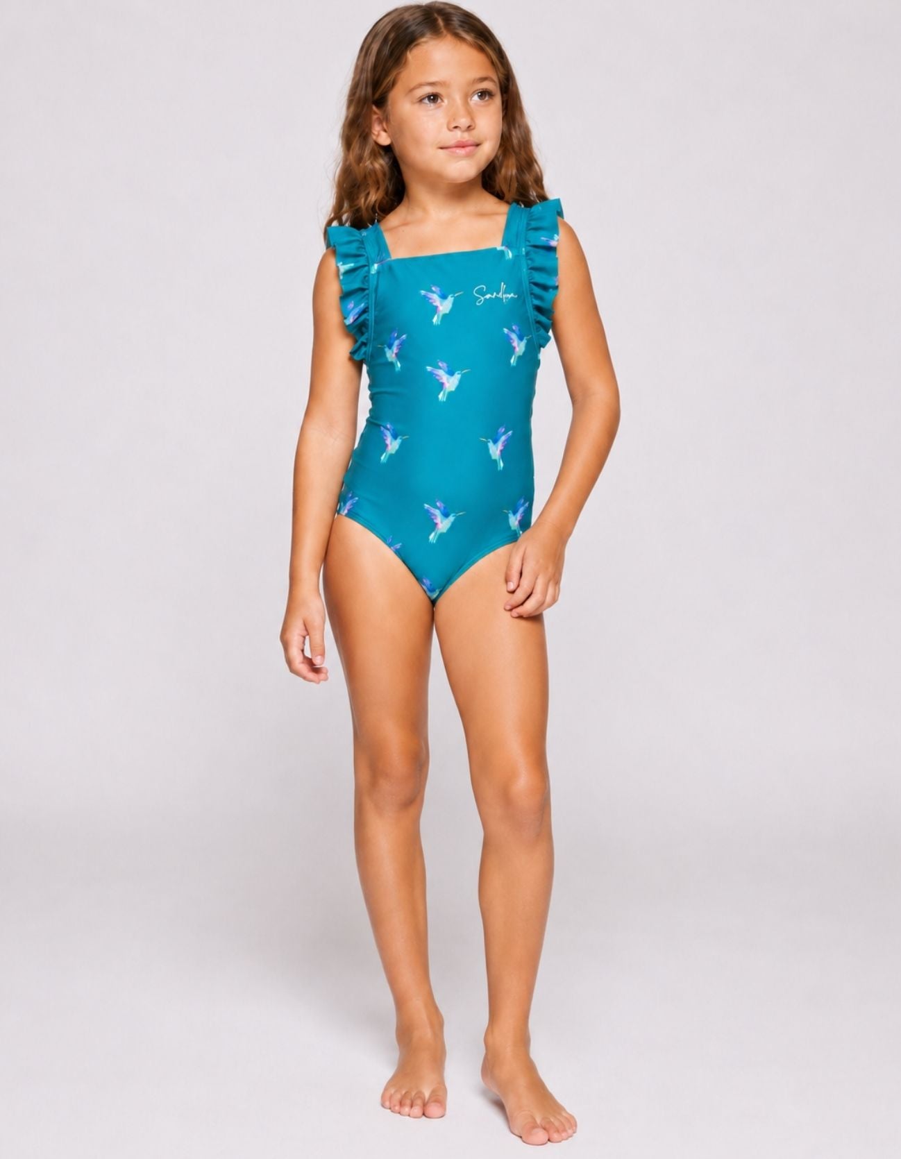 Kids teal hummingbird one-piece swimsuit with ruffle straps, front view, full