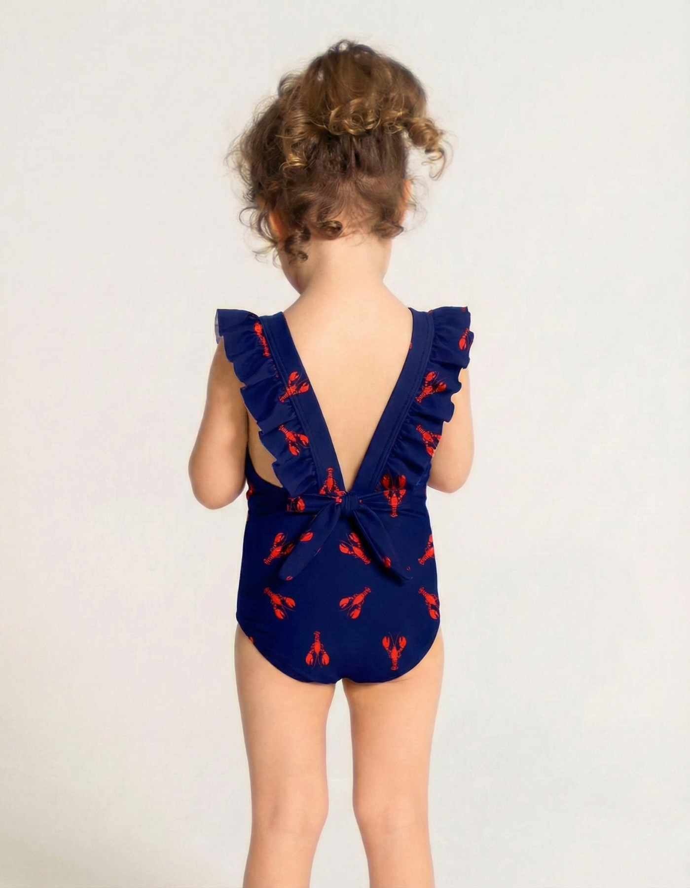 Red Lobster Girls Ruffle Swimsuit, back view. Sustainable girls swimwear.