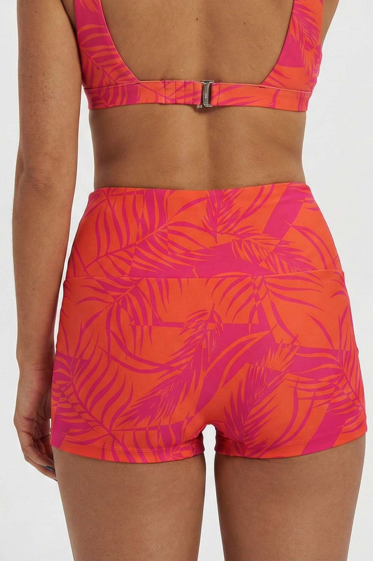 Aperol Palm / Coral Womens Reversible Swim Shorts, back view. Sustainable womens swimwear.