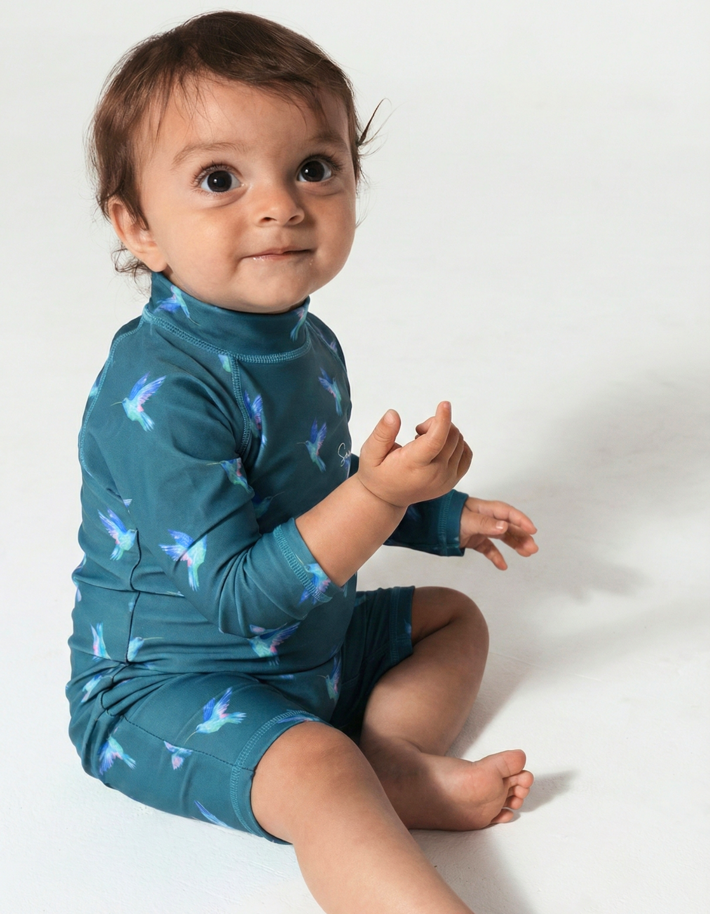 Hummingbird Baby Swimsuit, front view. Sustainable baby swimwear.