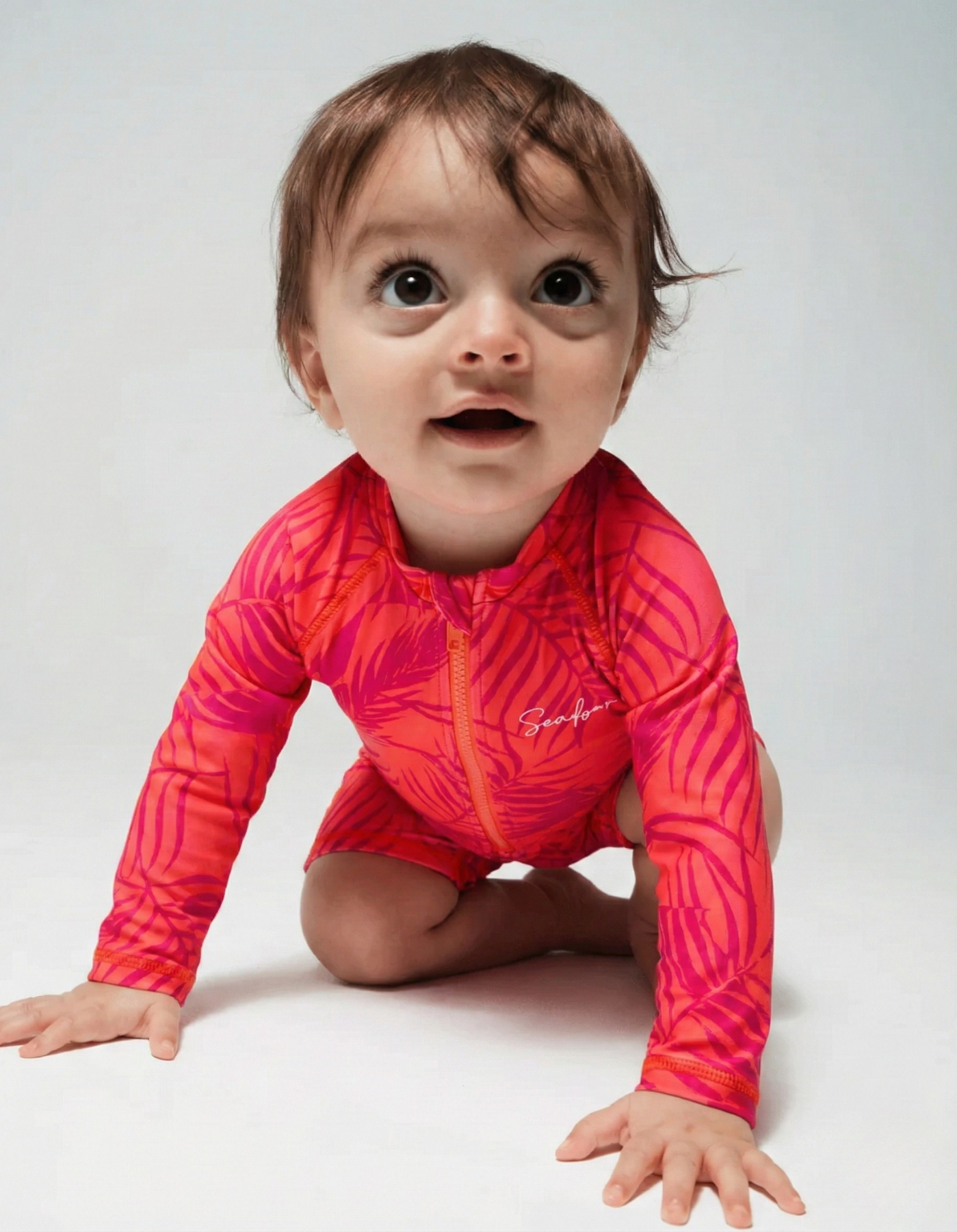 Aperol Palm Baby Swimsuit, front view. Sustainable baby swimwear.