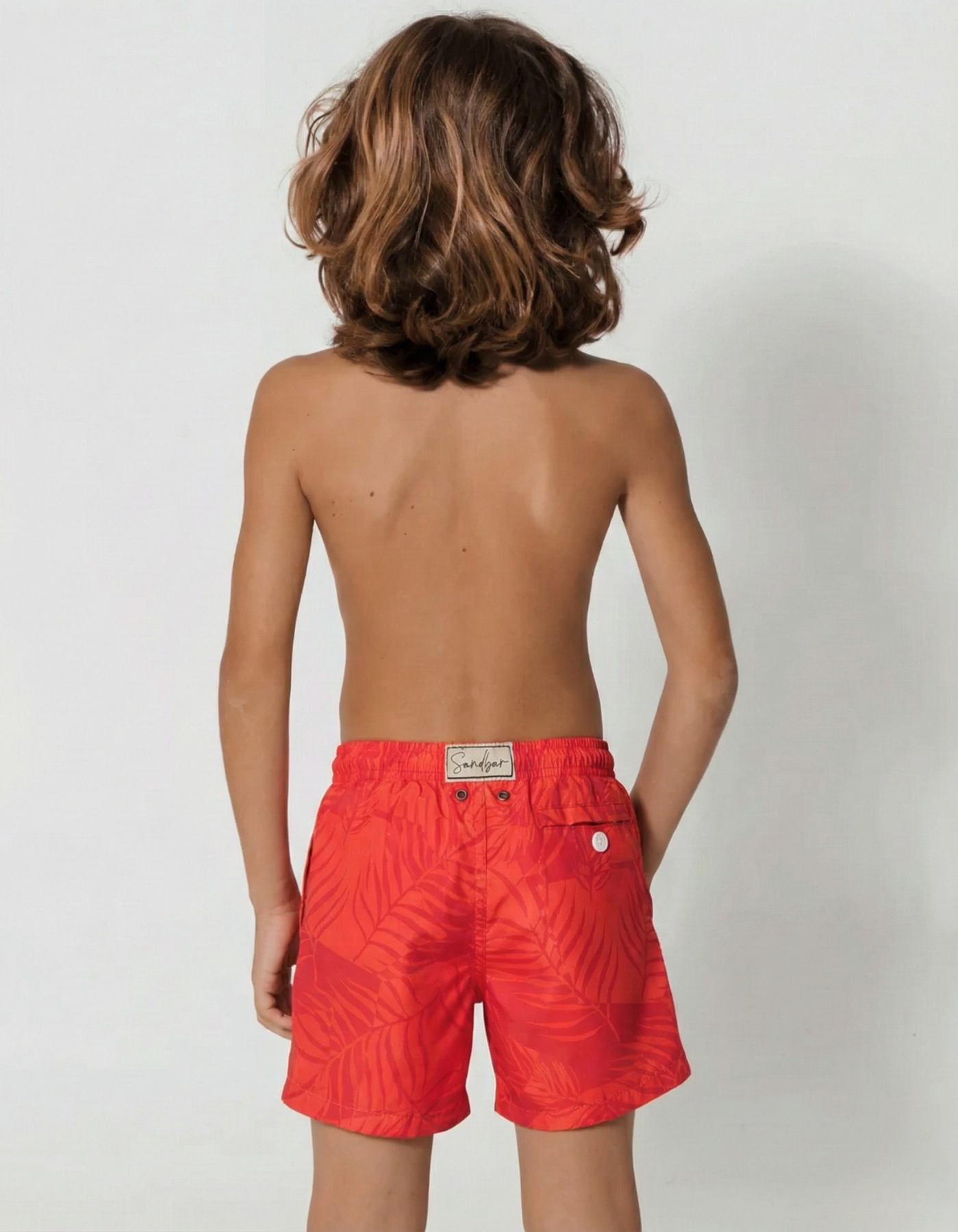 Aperol Palm Boys Swim Shorts, back view. Sustainable boys swimwear.