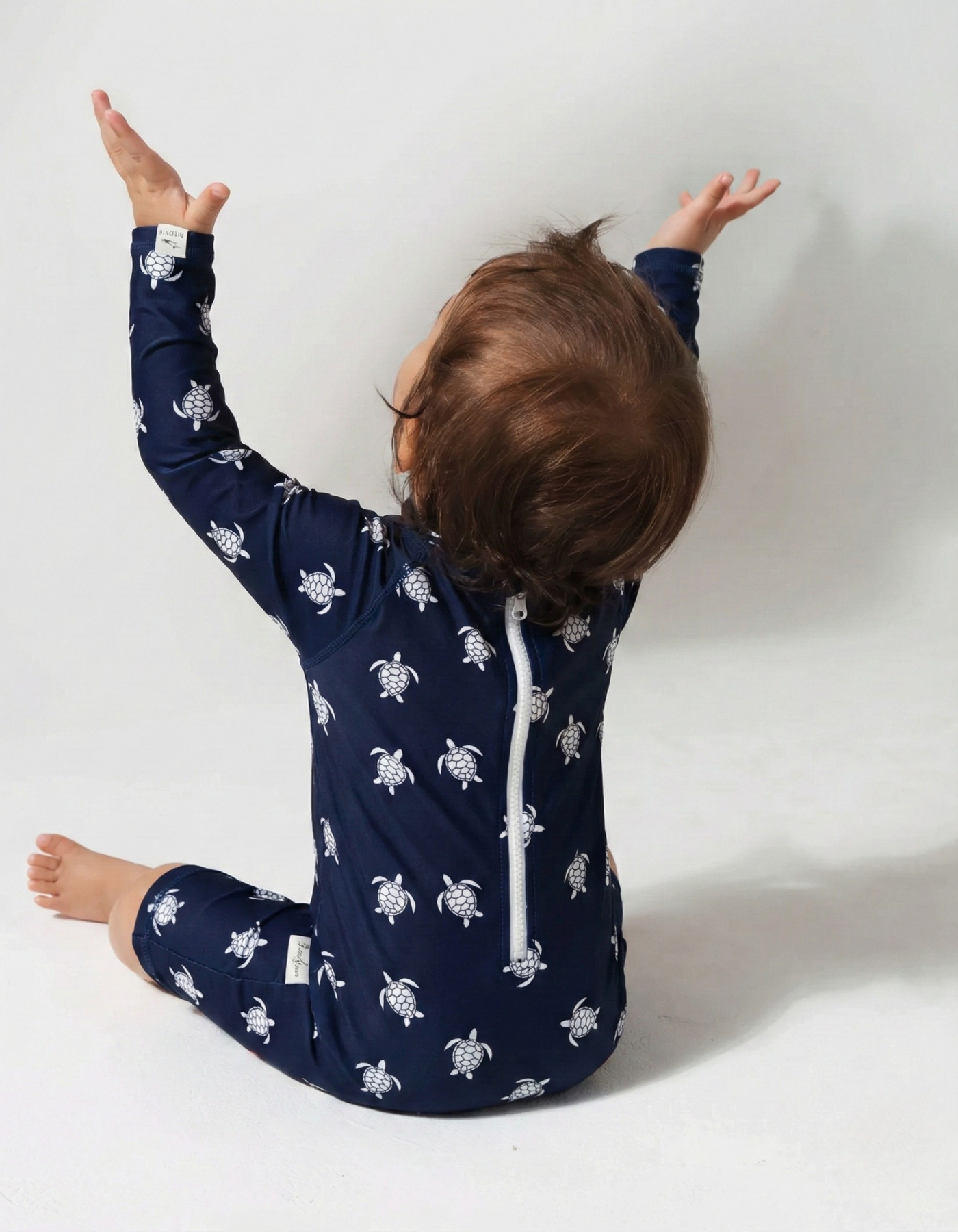 Navy Turtle Baby Swimsuit, back view. Sustainable baby swimwear.