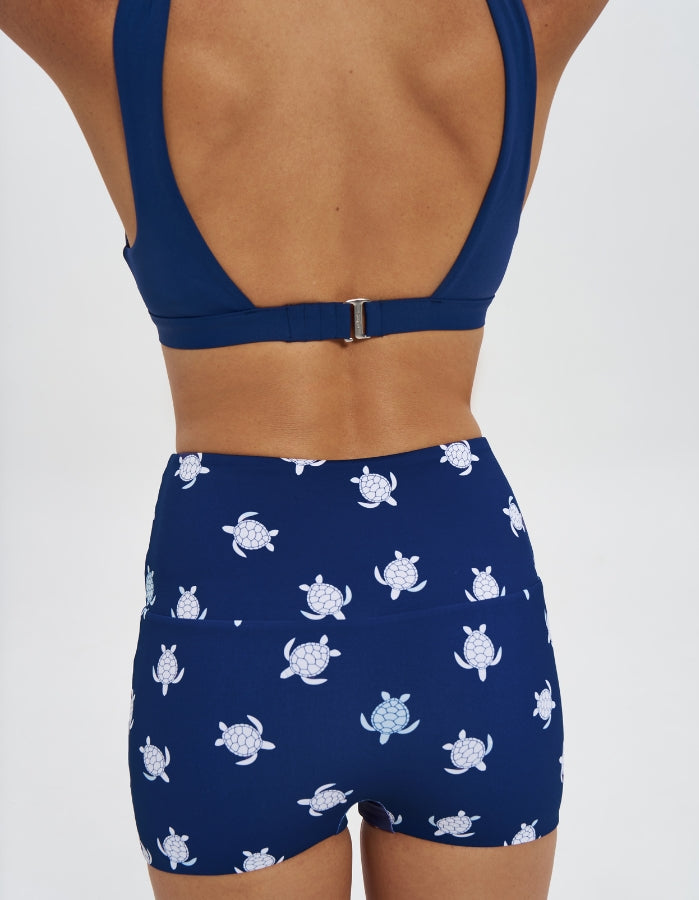 Navy Turtle / Navy Womens Reversible Swim Shorts, back view. Sustainable womens swimwear.