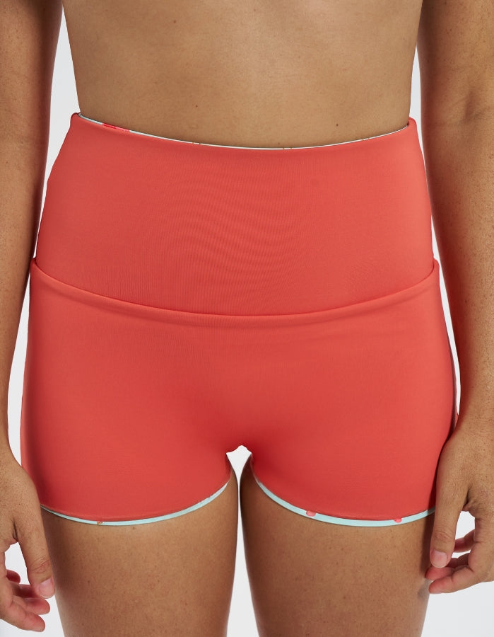 Pink Flamingo / Coral Womens Reversible Swim Shorts, front view. Sustainable womens swimwear.