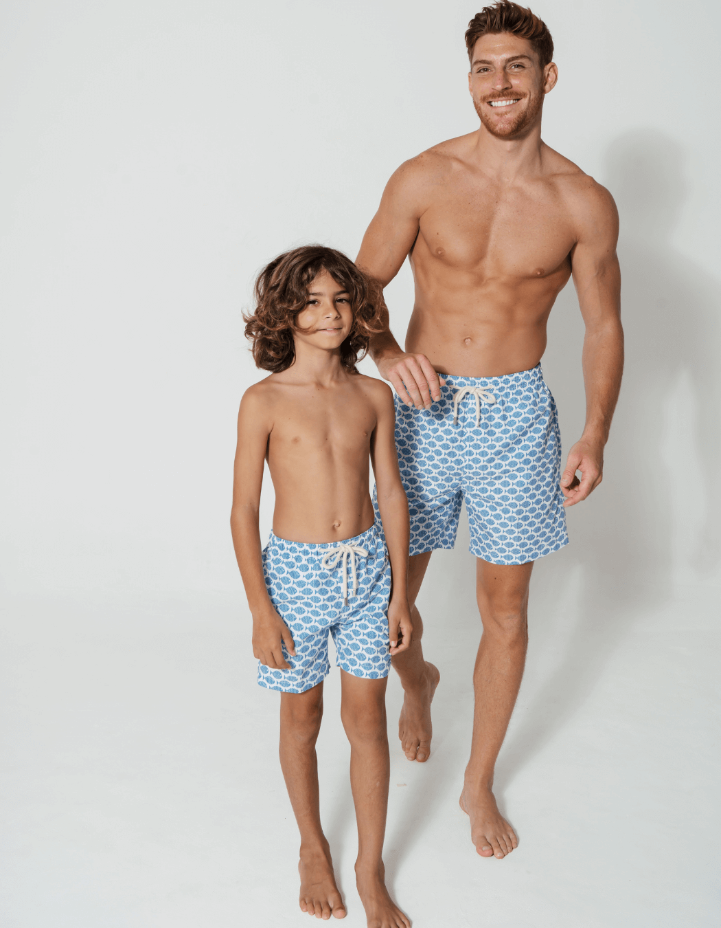 Baby Blue Fish Boys Swim Shorts, lifestyle shot. Sustainable baby swimwear.