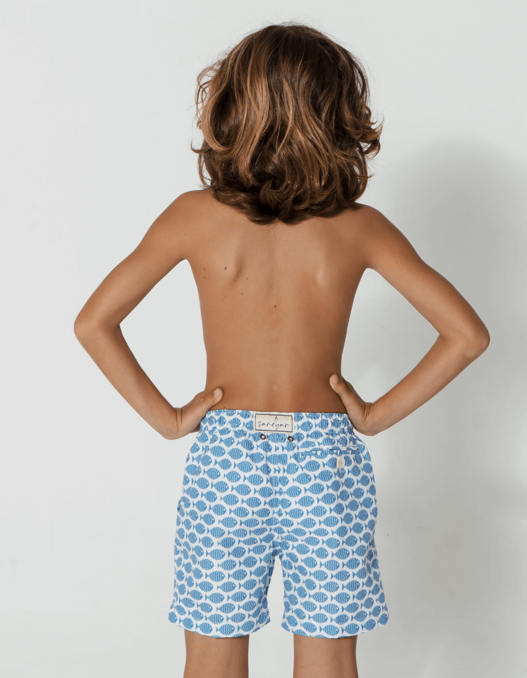 Baby Blue Fish Boys Swim Shorts, back view. Sustainable baby swimwear.