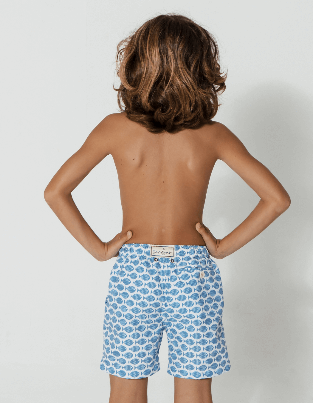 Baby Blue Fish Boys Swim Shorts, back view. Sustainable baby swimwear.