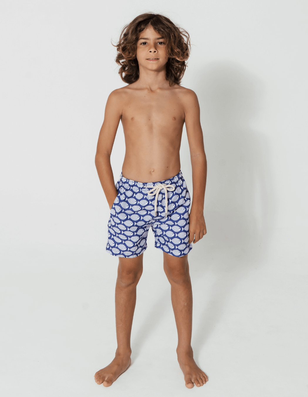 Blue Fish Boys Swim Shorts, lifestyle shot. Sustainable boys swimwear.