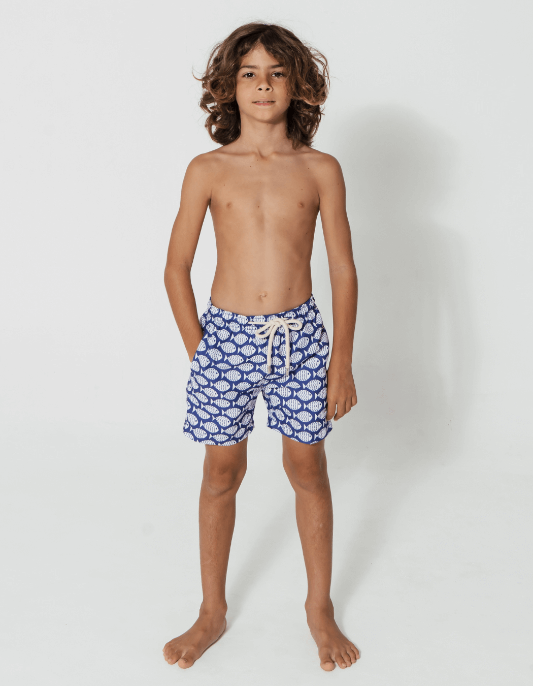 Blue Fish Boys Swim Shorts, lifestyle shot. Sustainable boys swimwear.