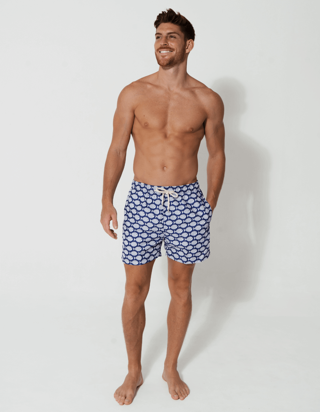 Blue Fish Mens Swim Shorts, lifestyle shot. Sustainable mens swimwear.