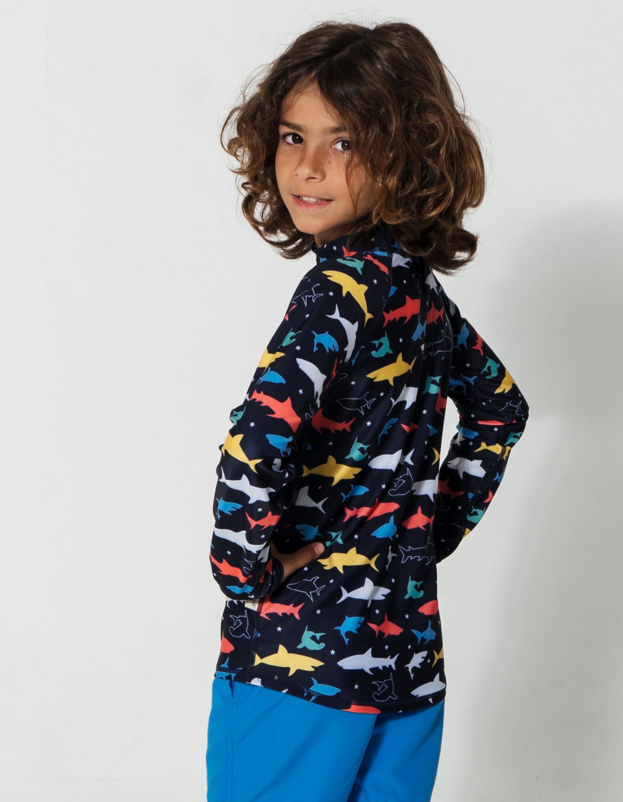 Colourful Sharks Rash Guard, lifestyle shot. Kids UPF50 rash guard.