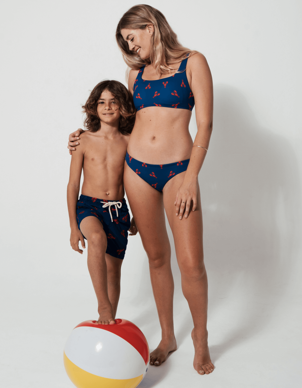 Family Matching Red Lobster, lifestyle shot. Family matching swimwear.