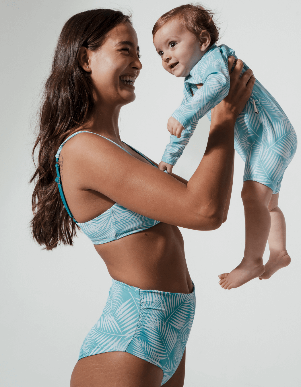 Green Fern Baby Swimsuit, back view. Sustainable baby swimwear.