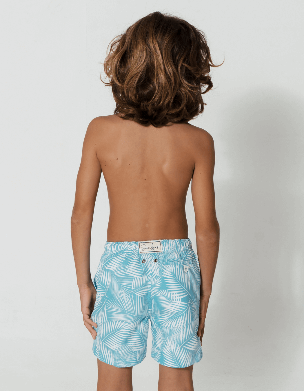 Green Fern Boys Swim Shorts, back view. Sustainable boys swimwear.