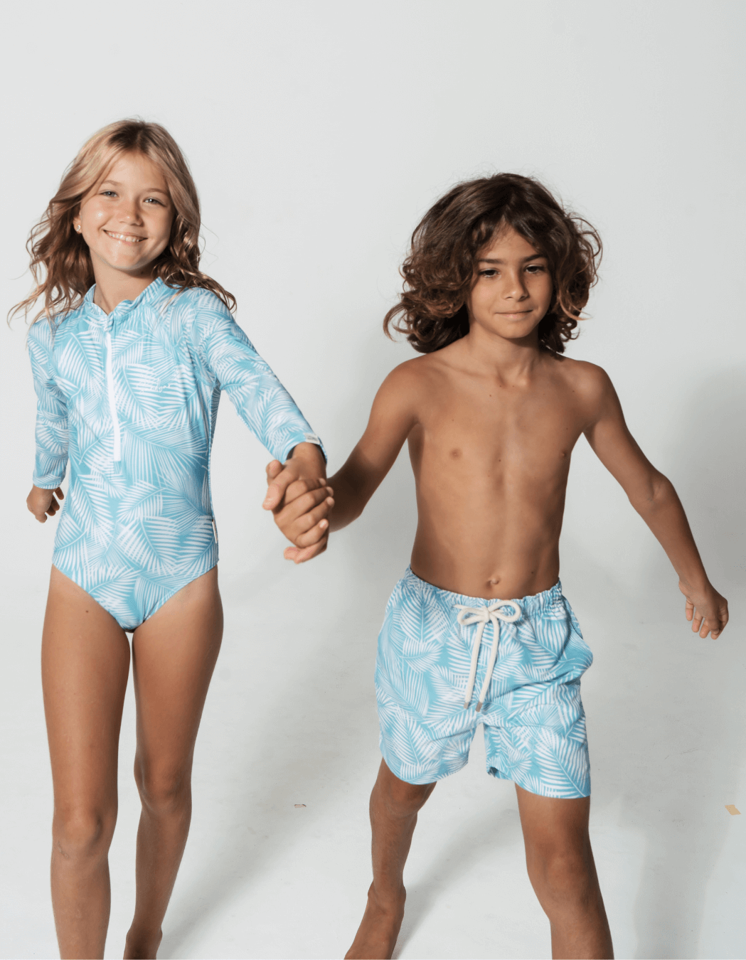 Green Fern Long Sleeved Girls Swimsuit, lifestyle shot. Sustainable girls swimwear.
