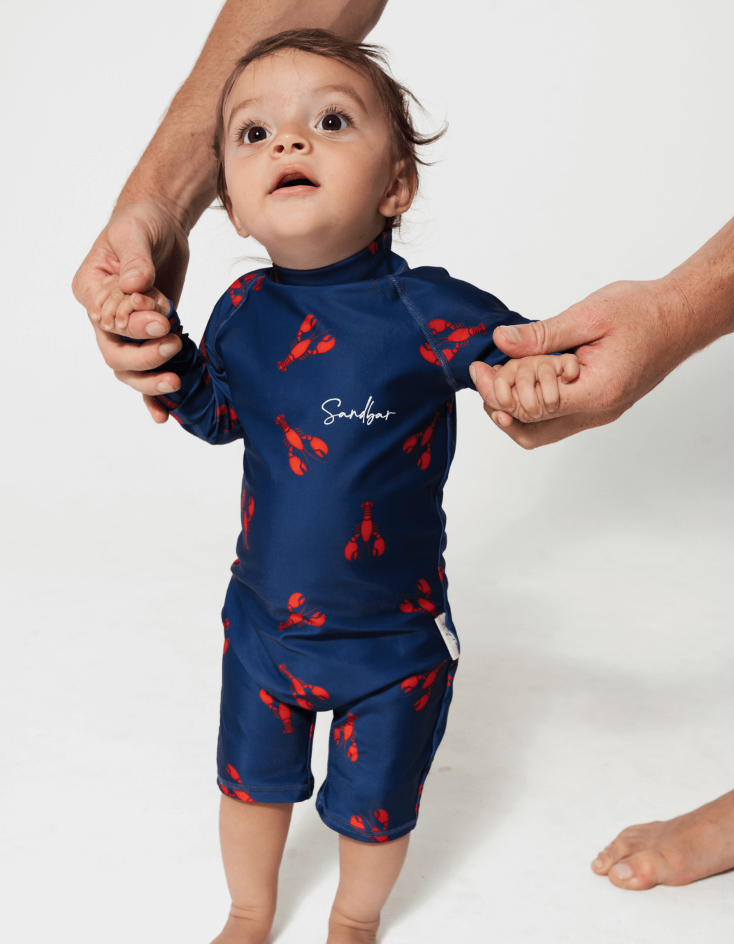 Lobster Baby Swimsuit, lifestyle shot. Sustainable baby swimwear.