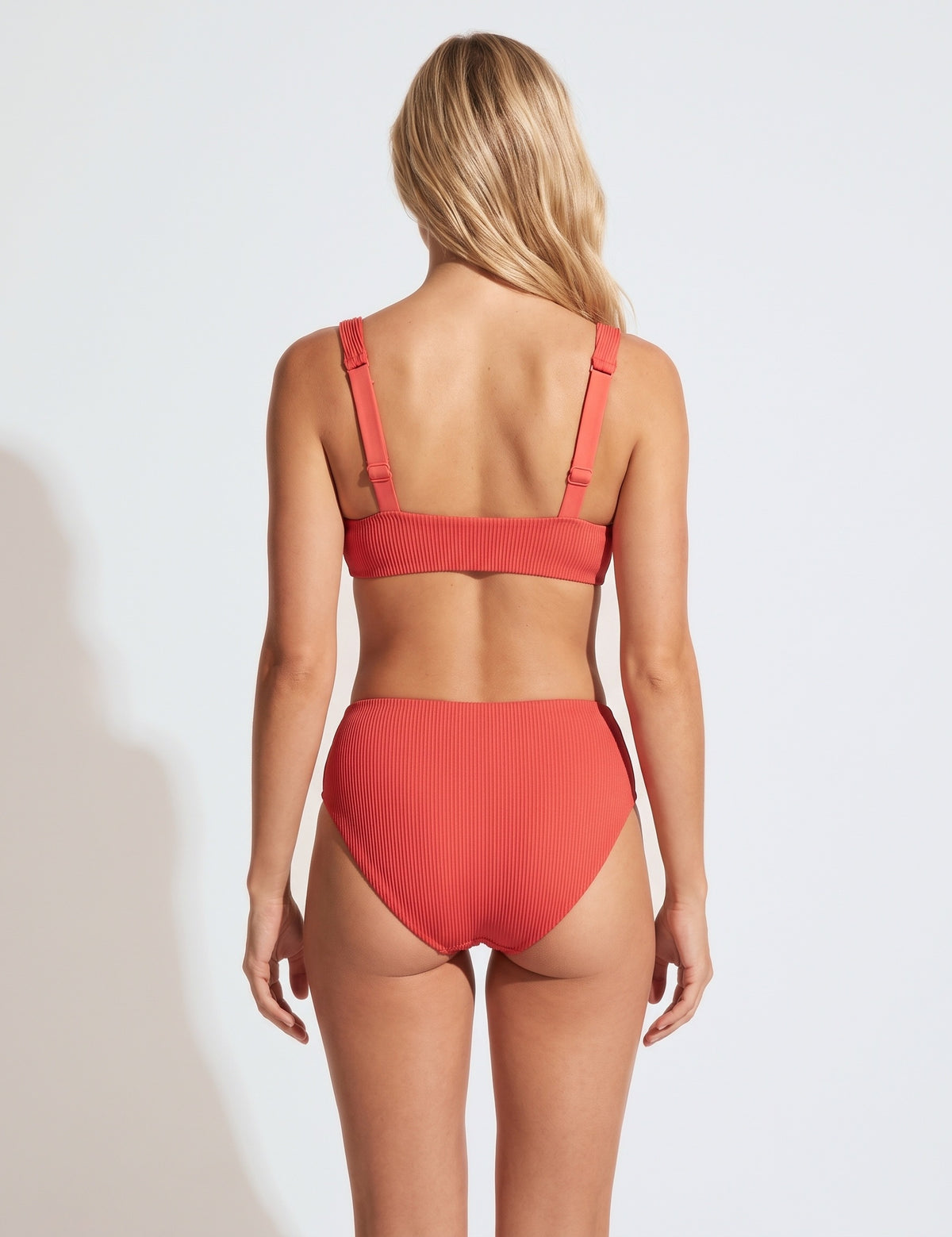 Mid Waist Coral ribbed bikini bottoms with a matching top, back view