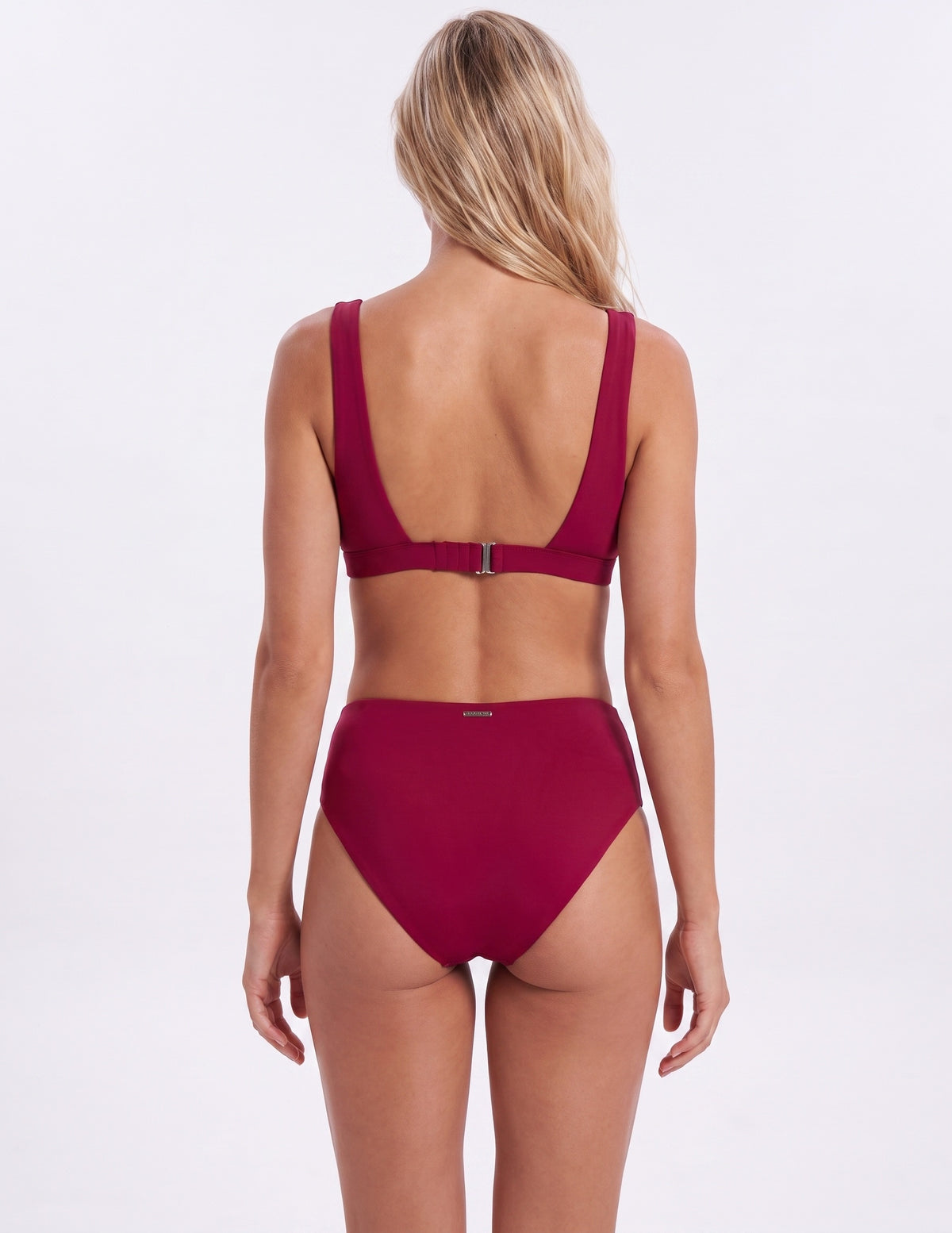 A woman shown from the back wearing a two-piece bikini in a deep burgundy or wine red color, set against a plain white studio background.