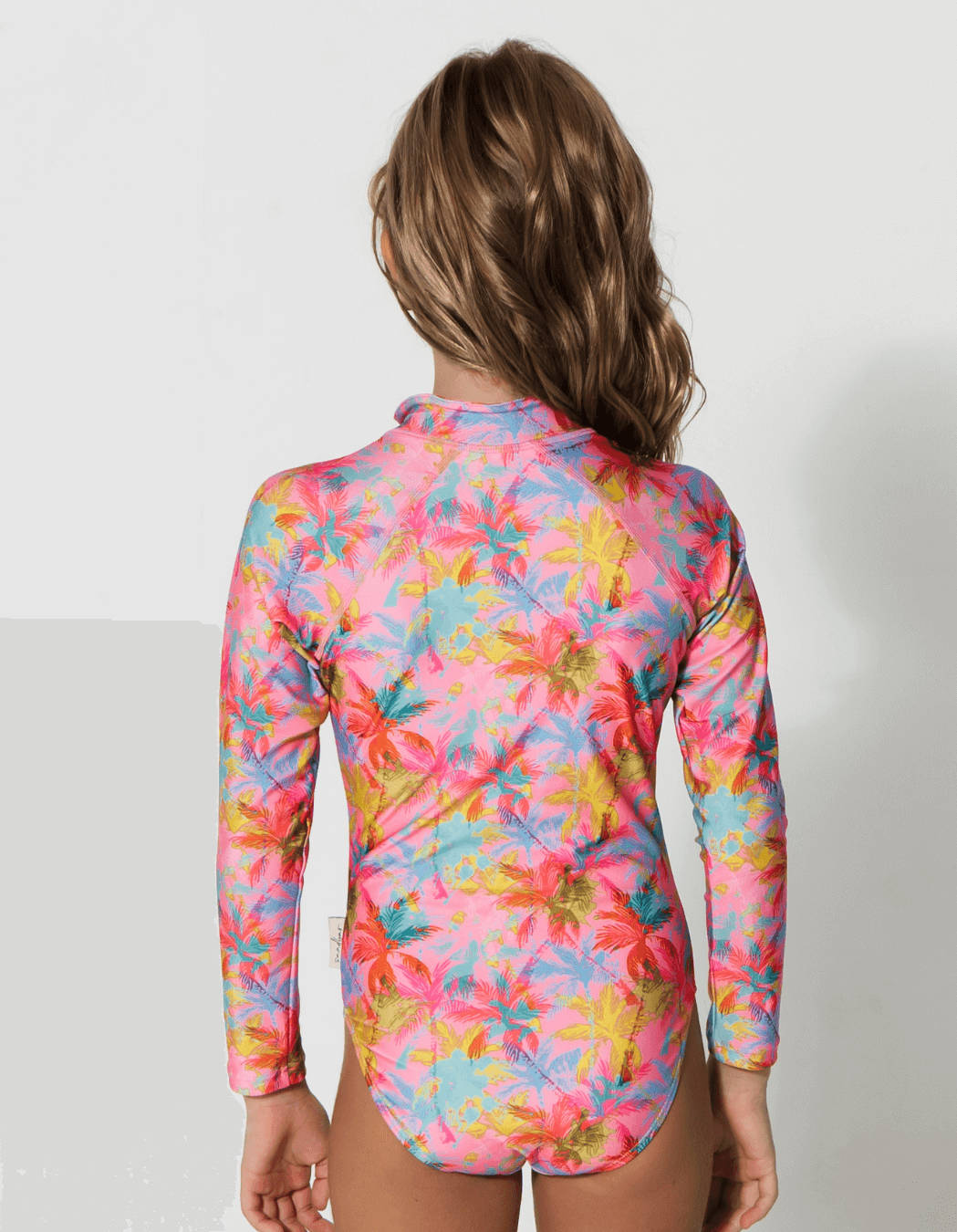 Pink Palm Long Sleeved Girls Swimsuit, back view. Sustainable girls swimwear.