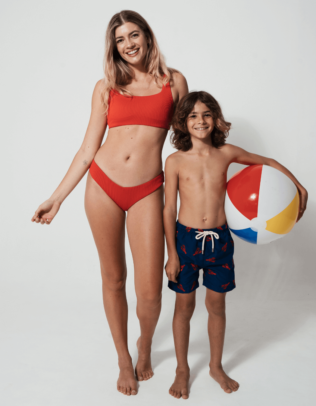 Printed Red Lobster Boys Swim Shorts, lifestyle shot. Sustainable boys swimwear.
