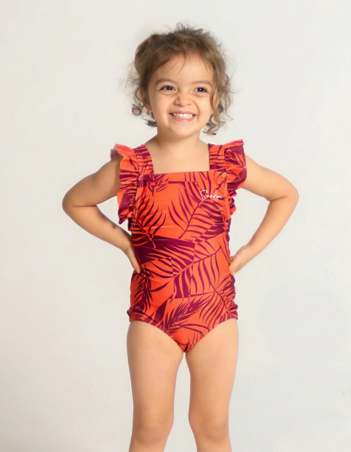 Sunset Palm Girls Ruffle Swimsuit, front view. Sustainable girls swimwear.