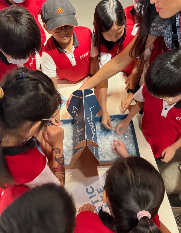 Schoolchildren at a Sandbar talk learning how plastic bottles become swimwear