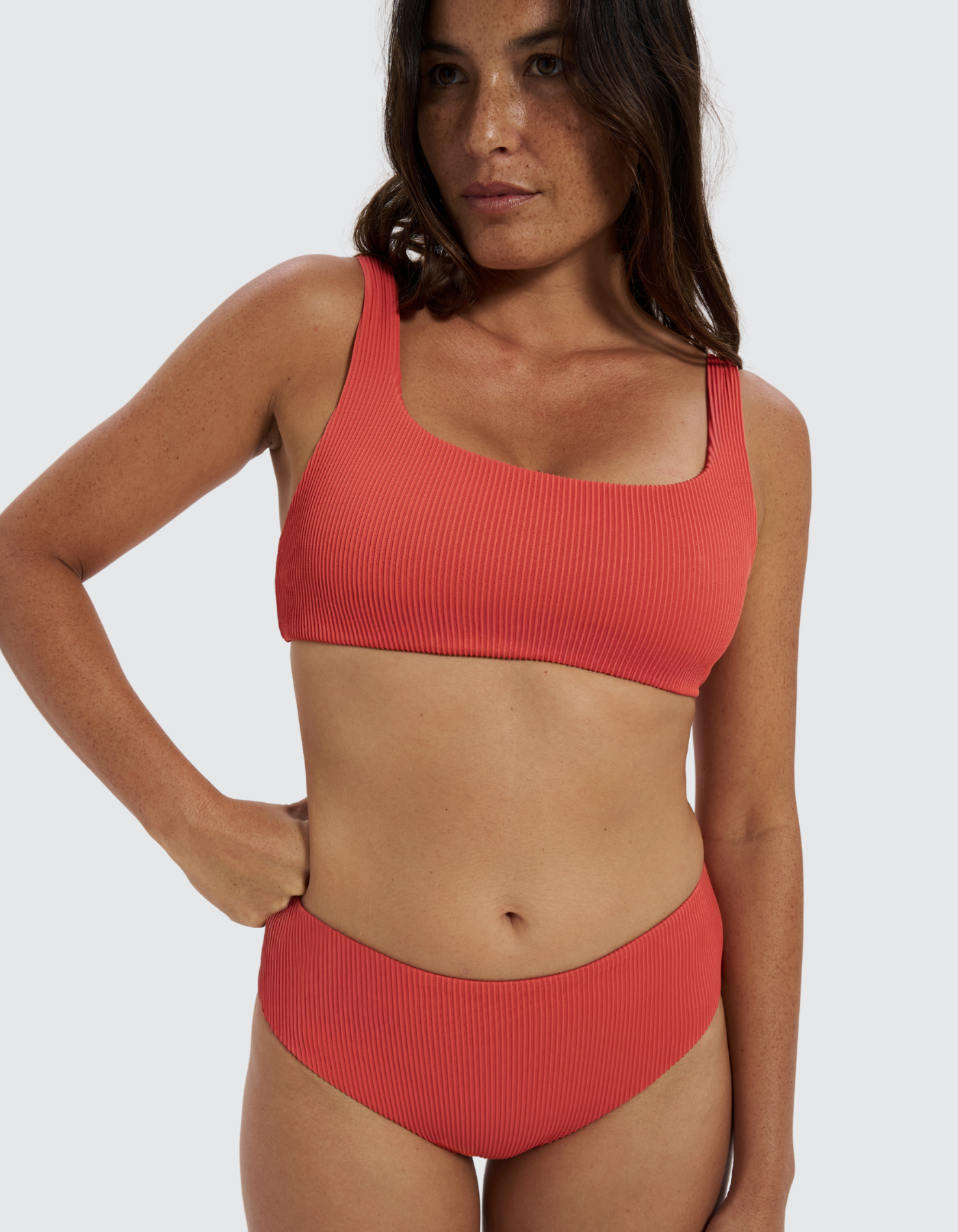 Mid Waist Coral Womens Ribbed Bikini Bottoms, front view. Sustainable womens swimwear.