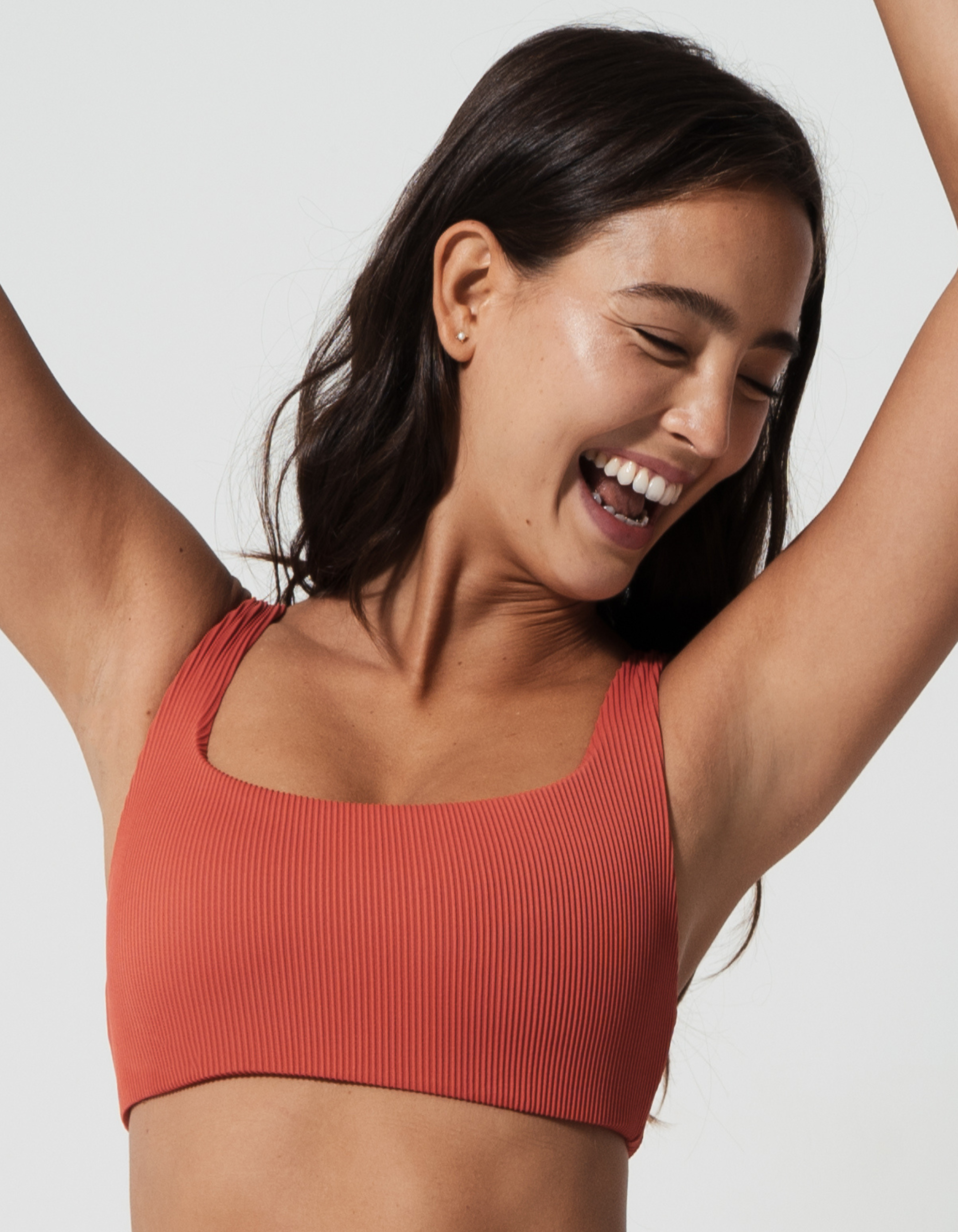Nikoi Coral Womens Ribbed Tank Bikini Top, front view. Sustainable womens swimwear.