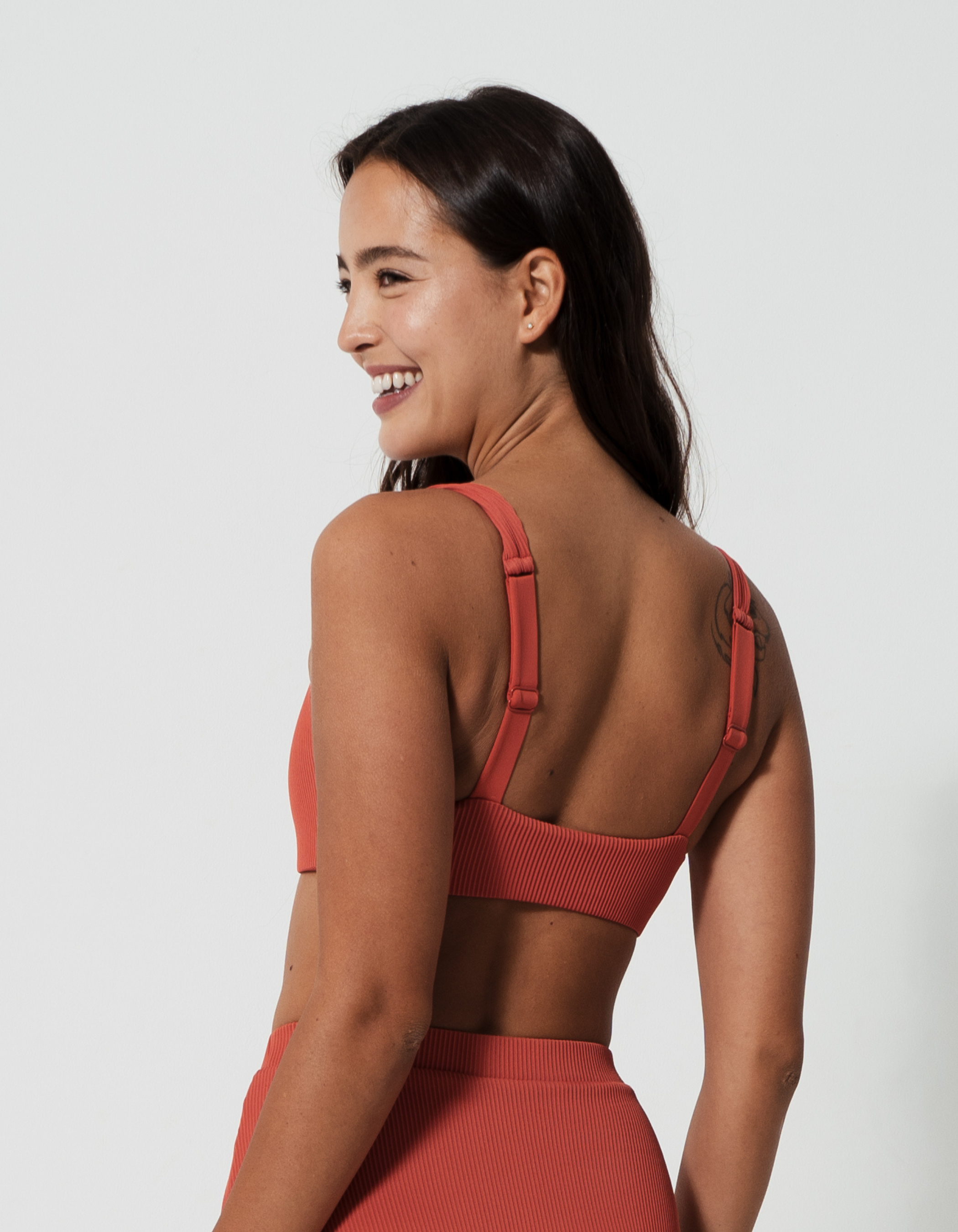 Nikoi Coral Womens Ribbed Tank Bikini Top, back view. Sustainable womens swimwear.