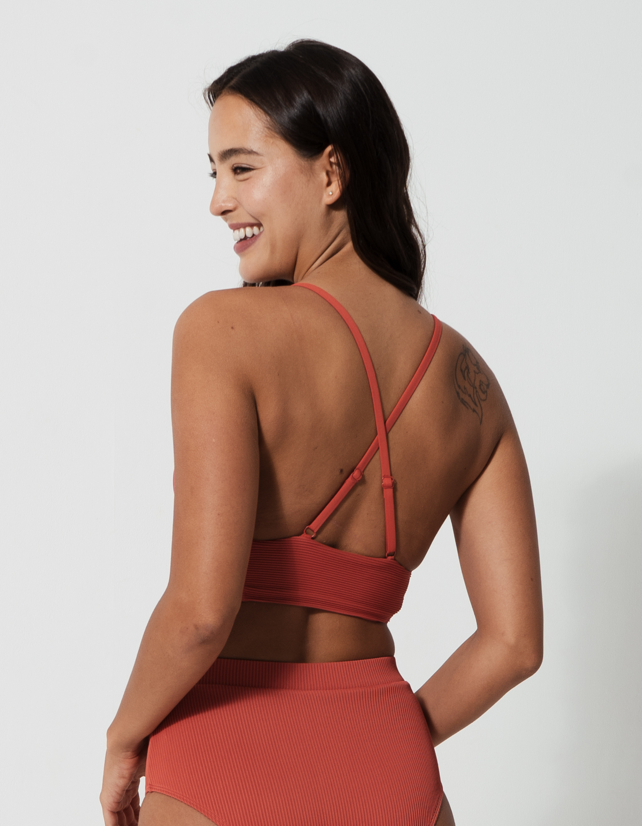 Flores Coral Womens Ribbed Plunge Bikini Top, back view. Sustainable womens swimwear.
