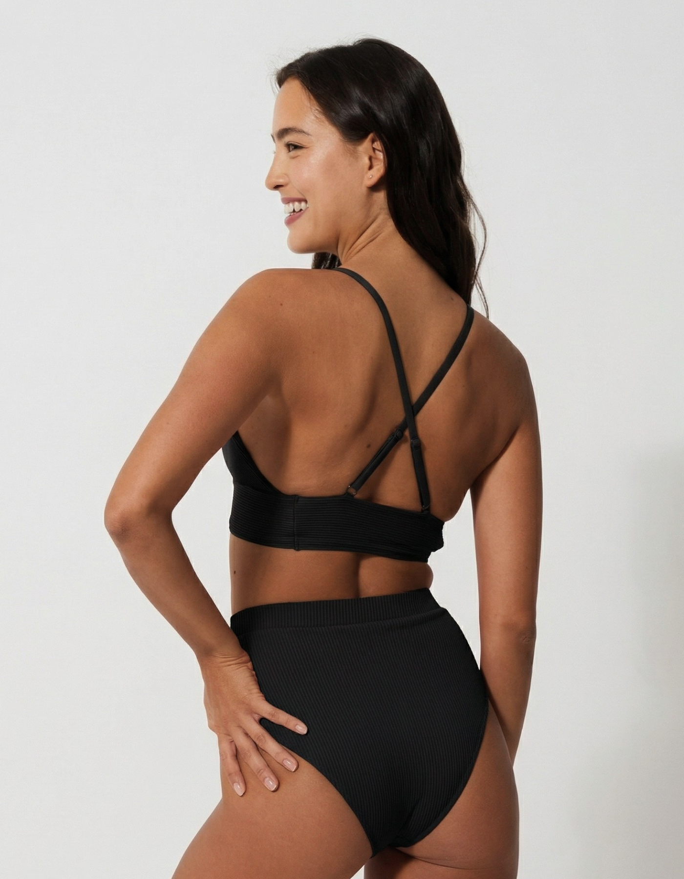 Flores Black Womens Ribbed Plunge Bikini Top, back view. Sustainable womens swimwear.