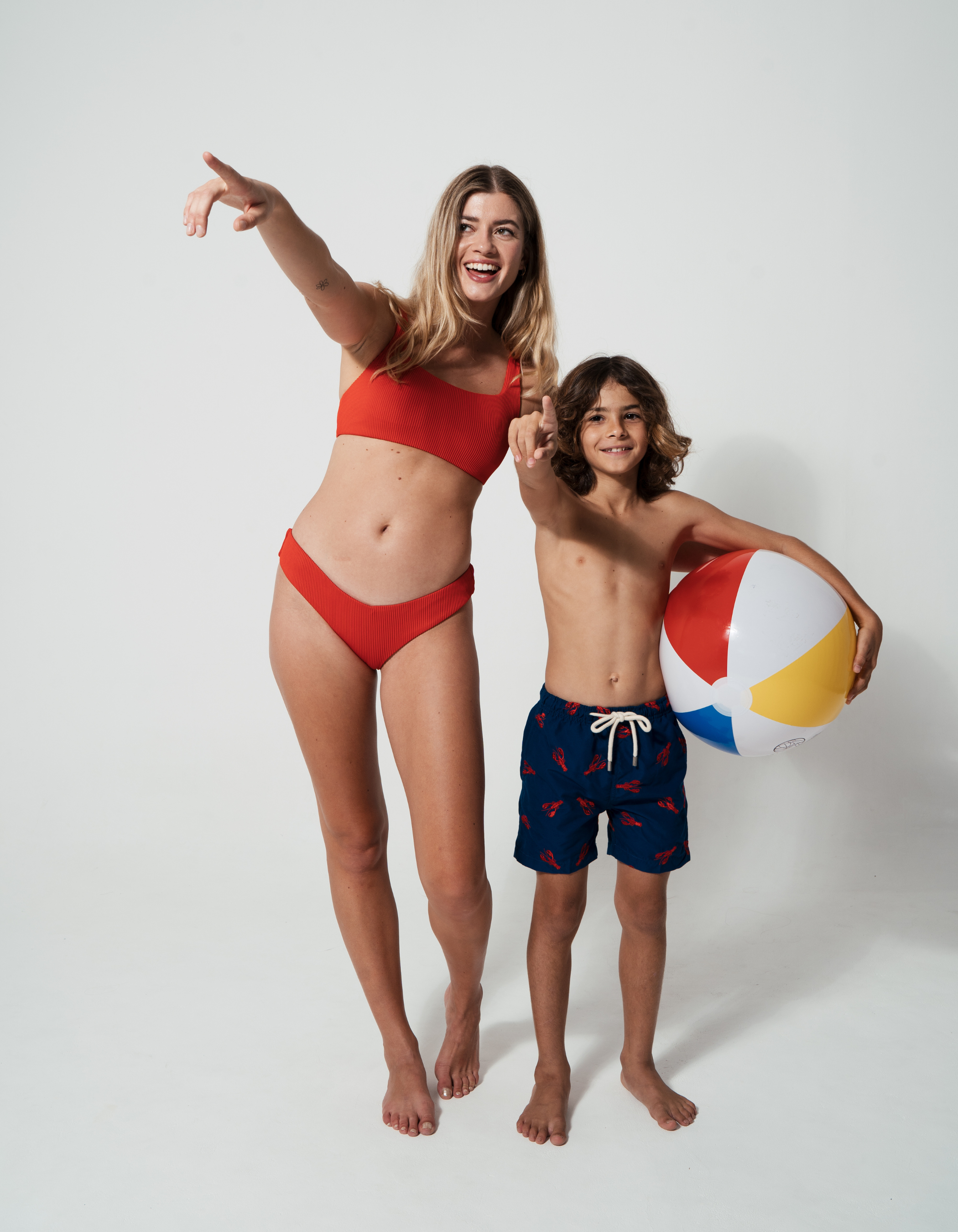 Low Waist Lipstick Red Womens Ribbed Bikini Bottoms, lifestyle shot. Sustainable womens swimwear.