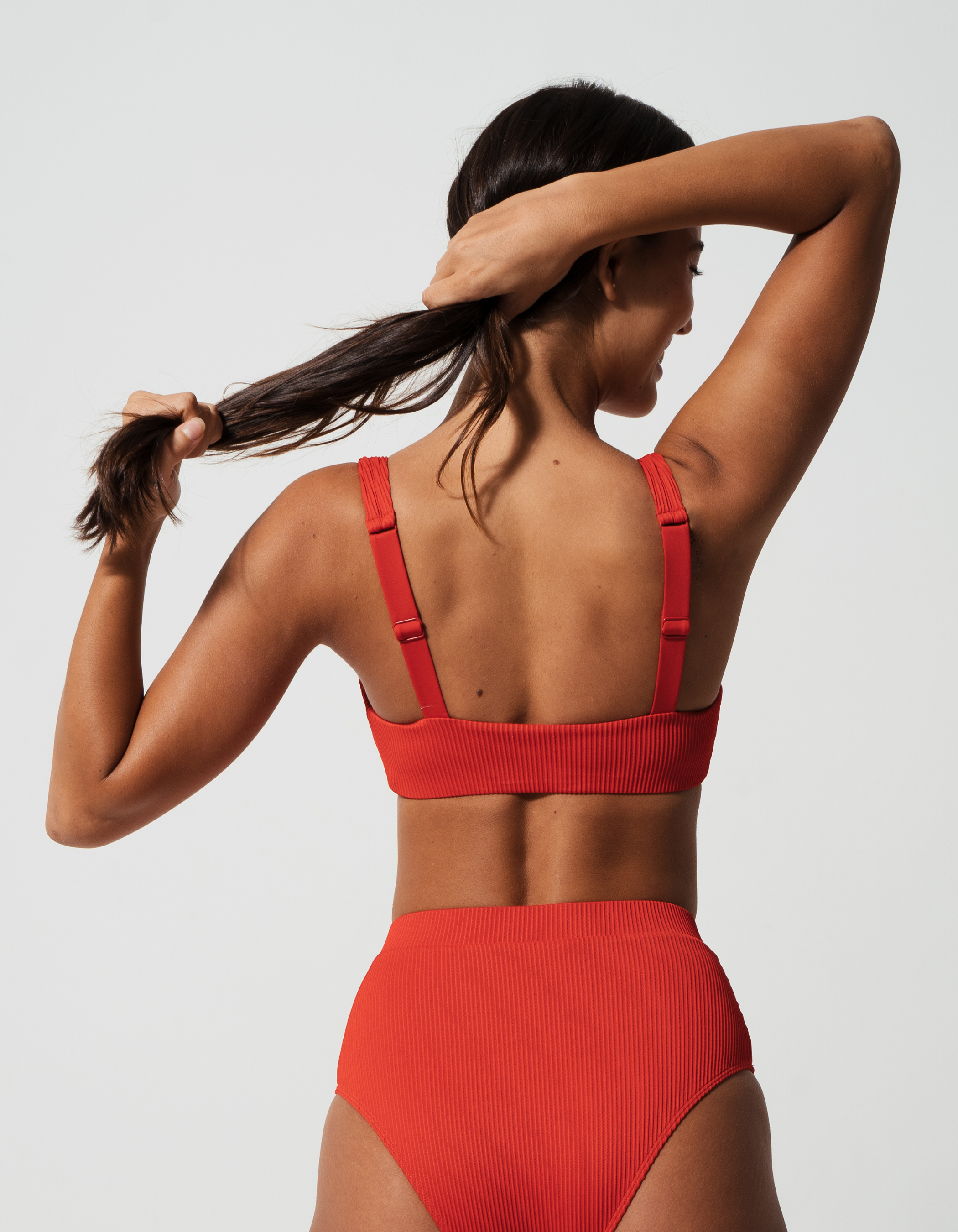 Nikoi Lipstick Red Womens Ribbed Tank Bikini Top, back view. Sustainable womens swimwear.